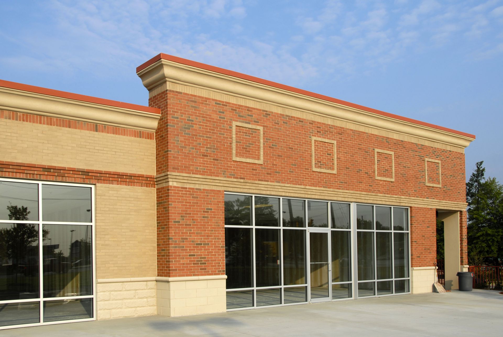 Street-level view of commercial building façade enhanced by reflective heat resistant film on glass.