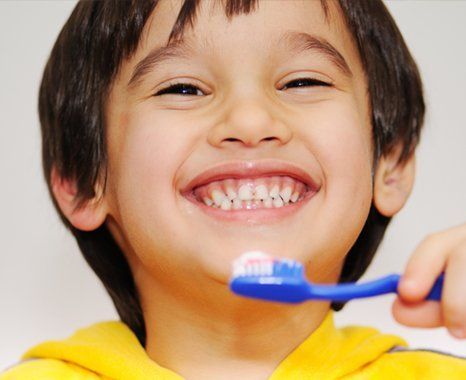 A boy holding his toothbrush