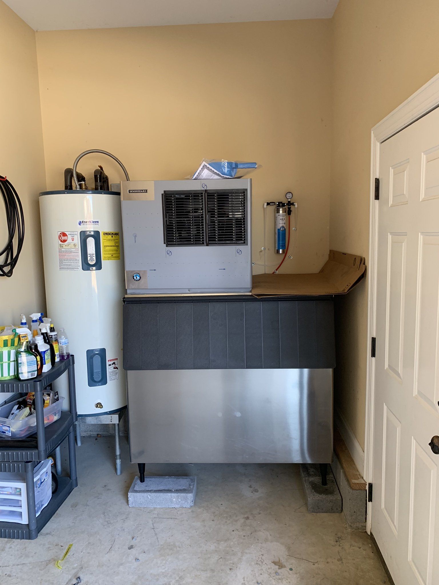 A room with a water heater and an ice machine