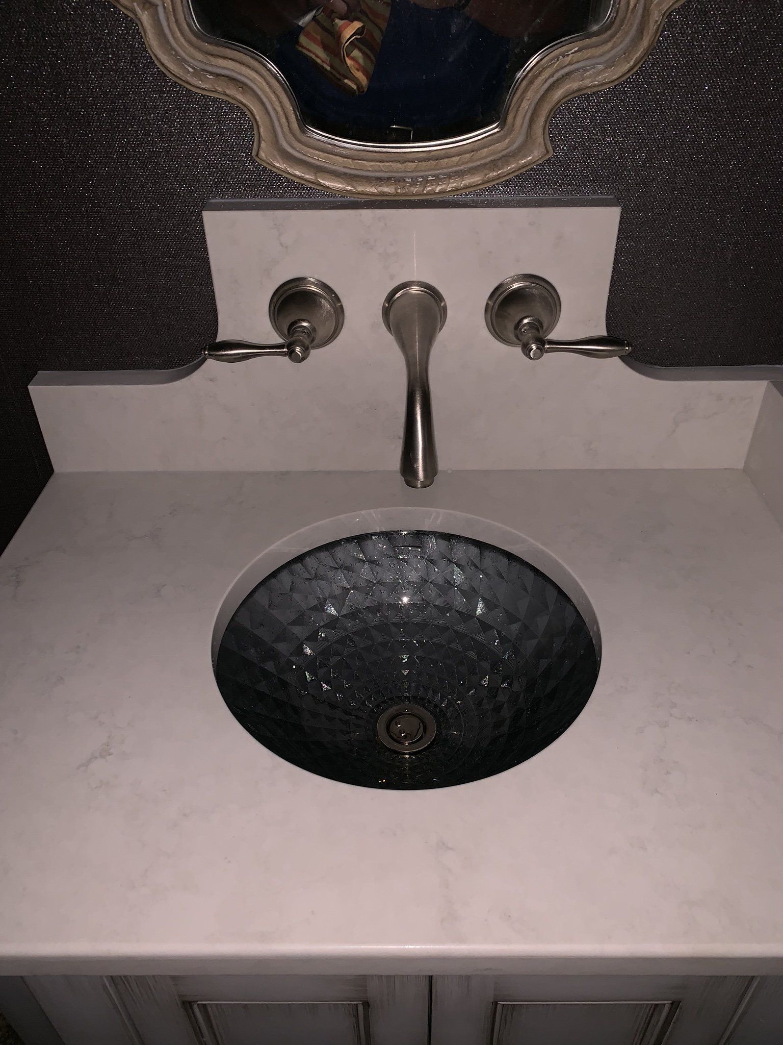 A bathroom sink with a mirror above it and a faucet.