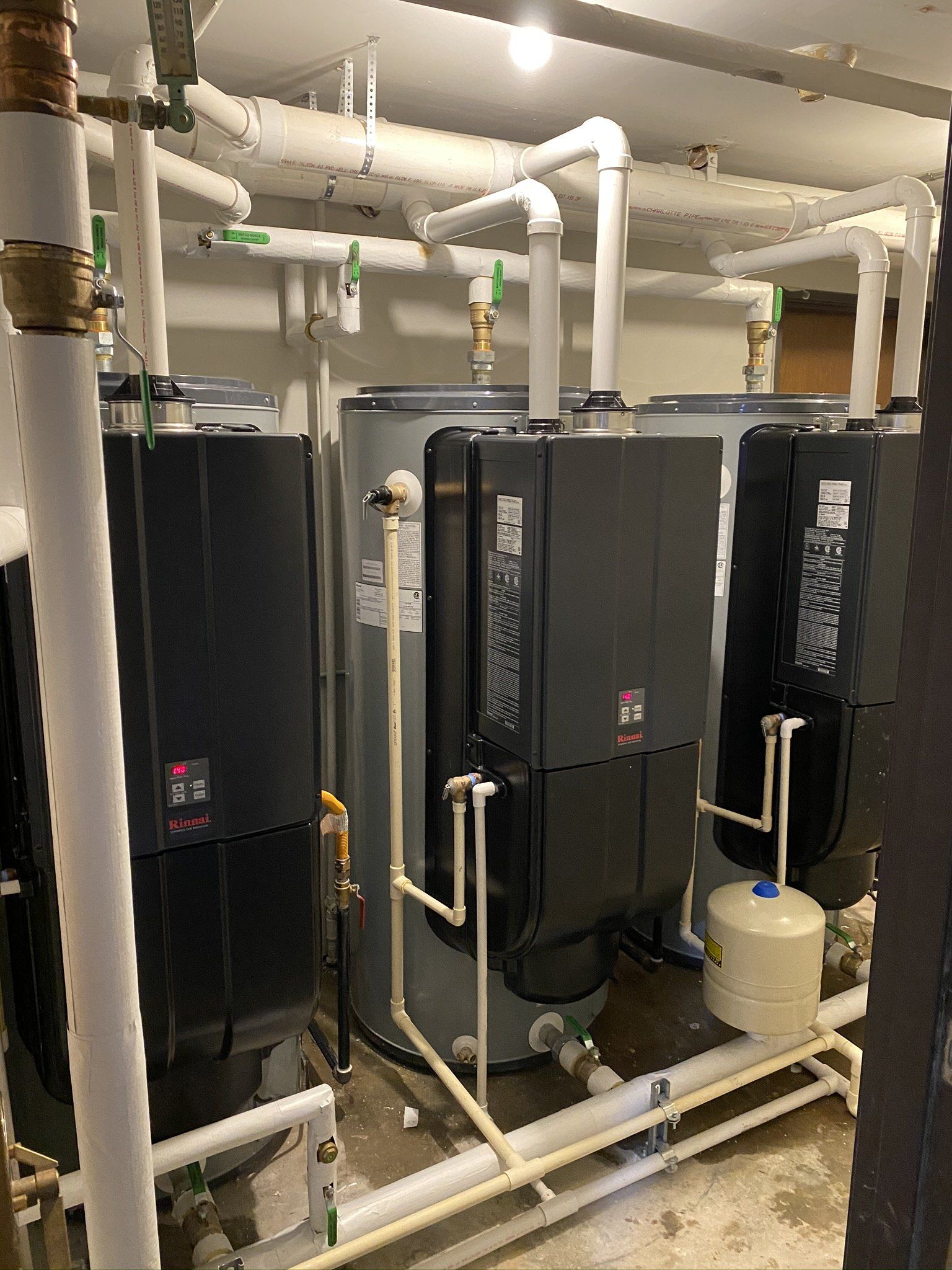 A room filled with water heaters and pipes.