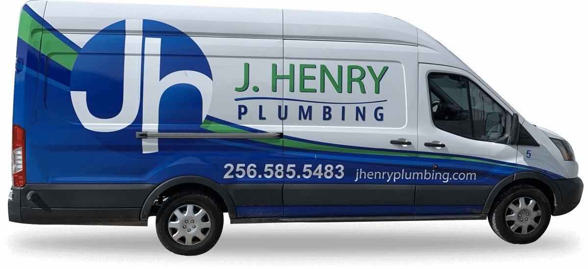 J. henry plumbing van is sitting on a white surface .
