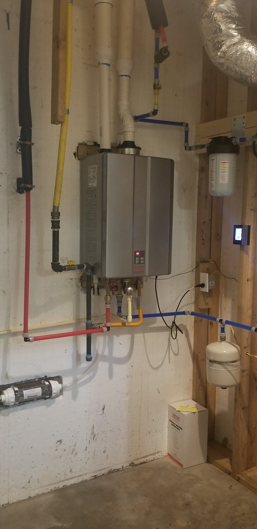 There is a water heater in the corner of the room.