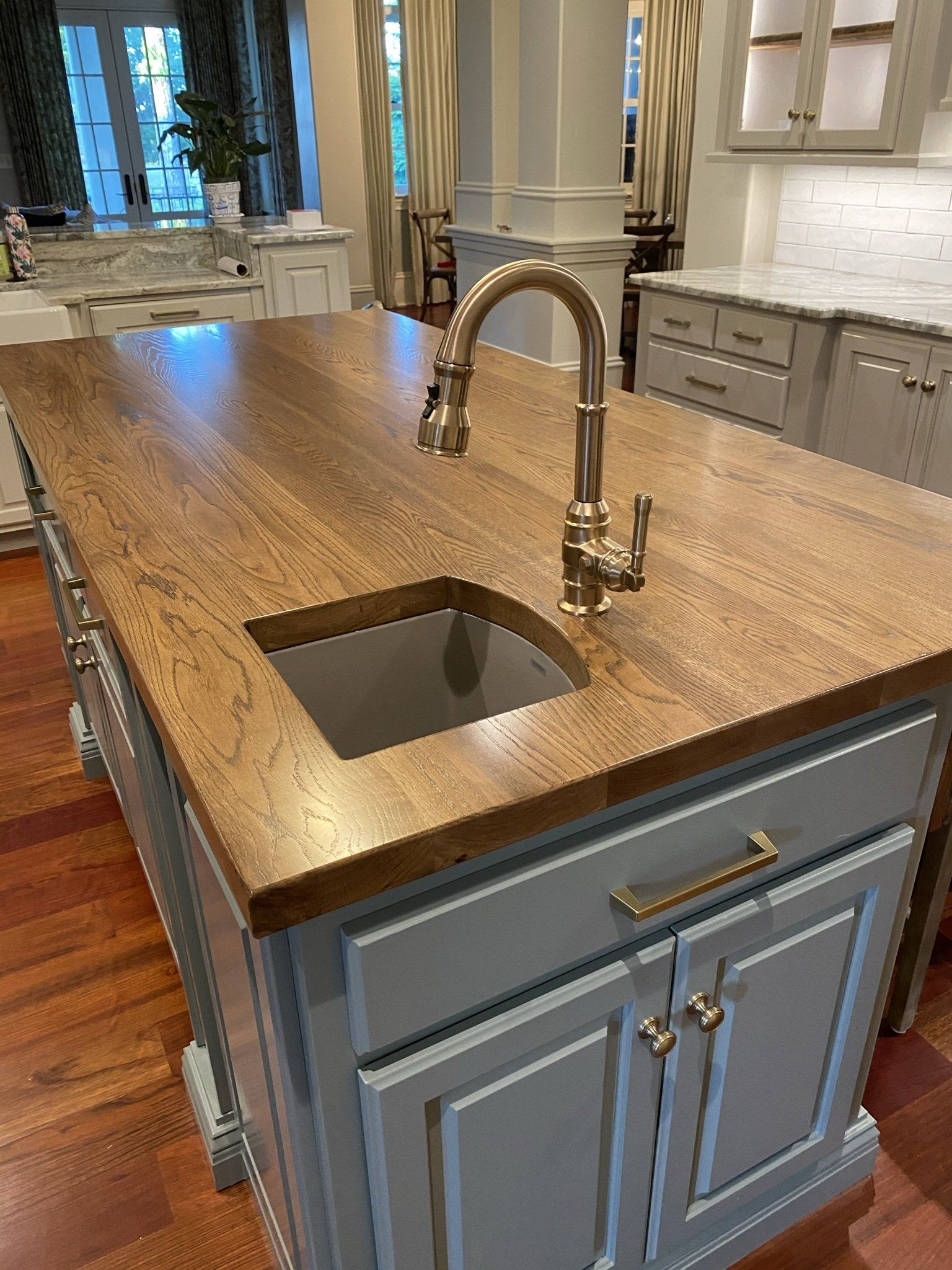 A kitchen island with a sink and faucet on it.