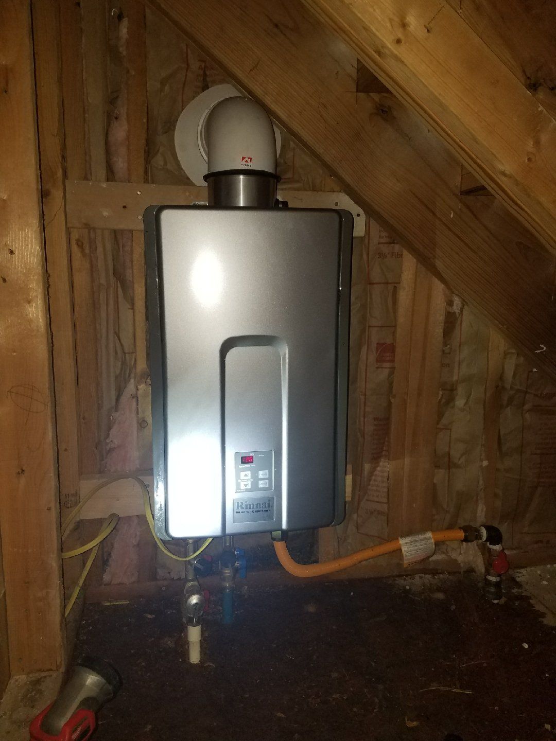 A water heater is installed in the attic of a house.