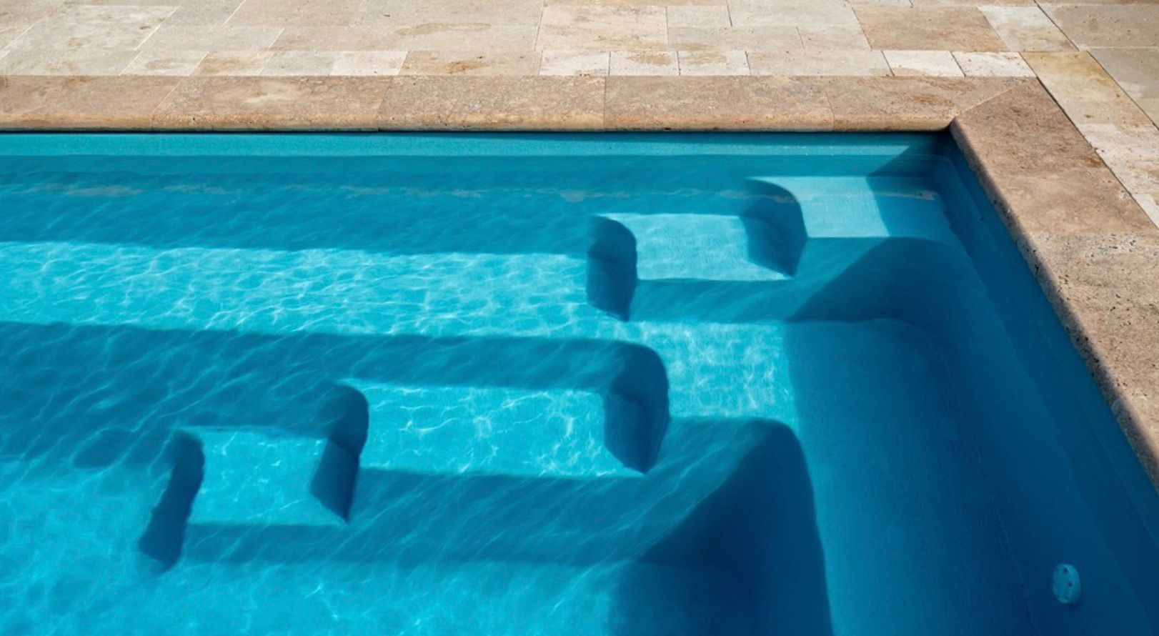 A swimming pool with stairs leading up to it