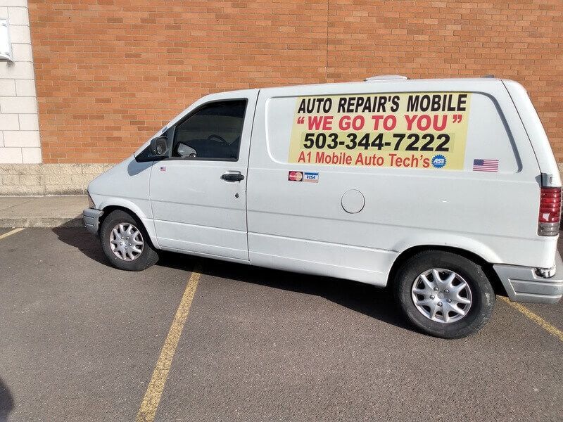 A white van that says auto repair 's mobile we go to you.