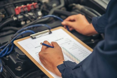 Mechanic inspecting a car engine.