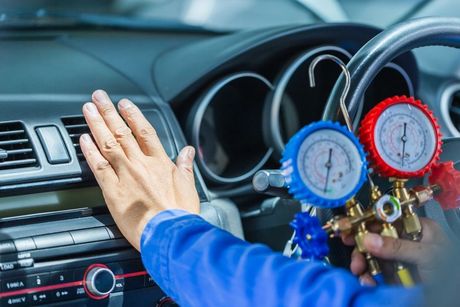 Mechanic checking a car's air conditioning.