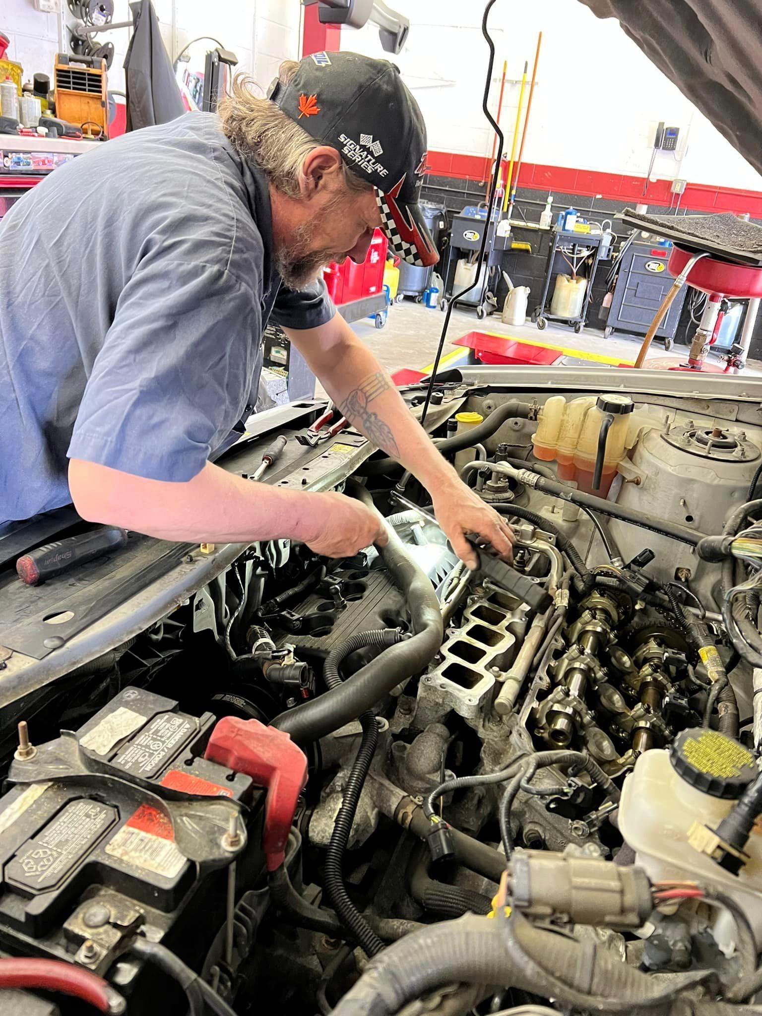 Mechanic working on engine | The Car Doctor
