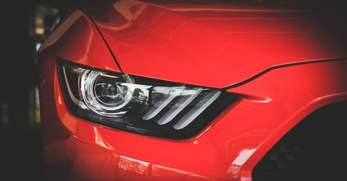 A close up of a red car 's headlight.  | The Car Doctor