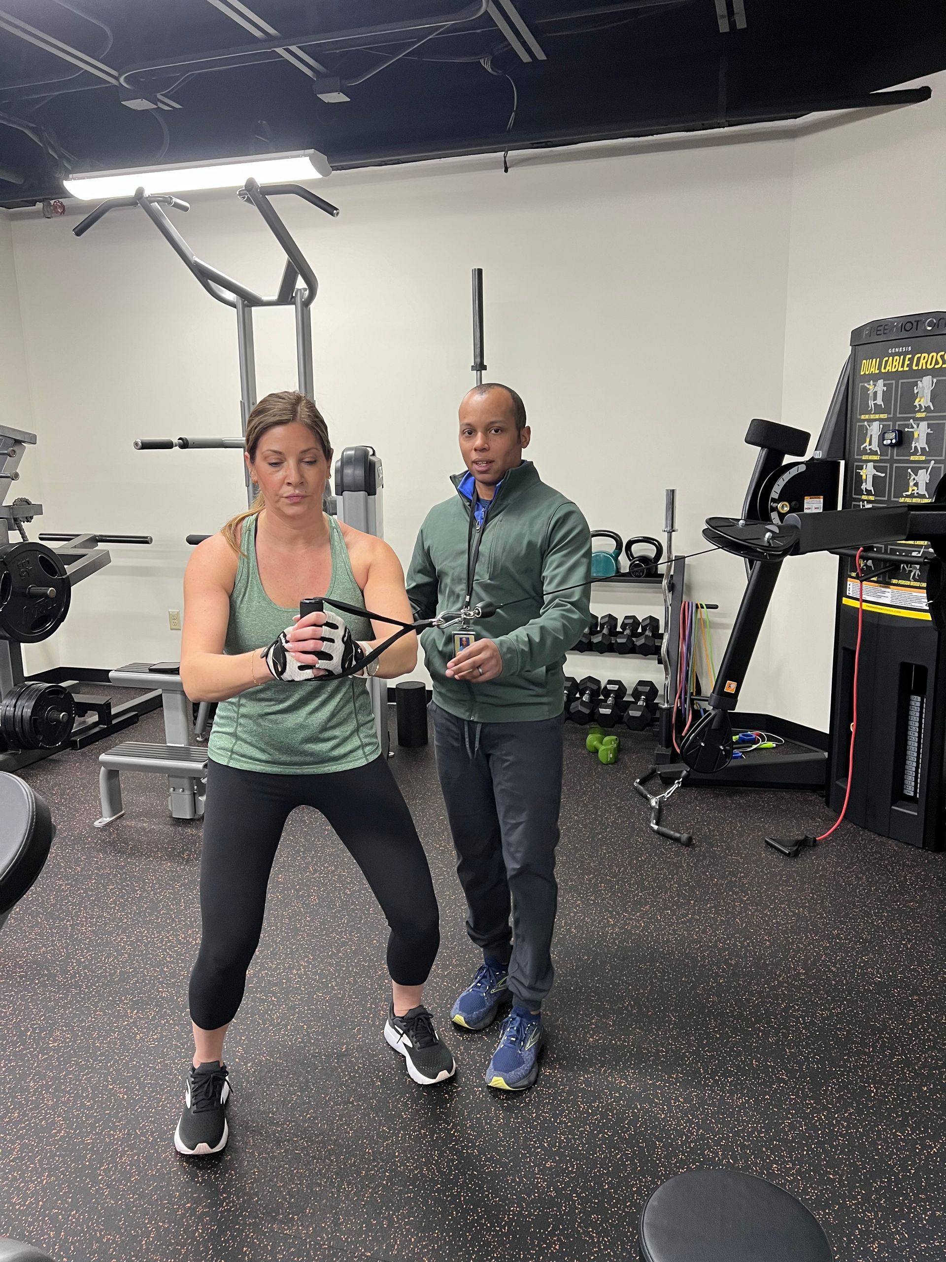 A man and a woman are doing exercises in a gym.