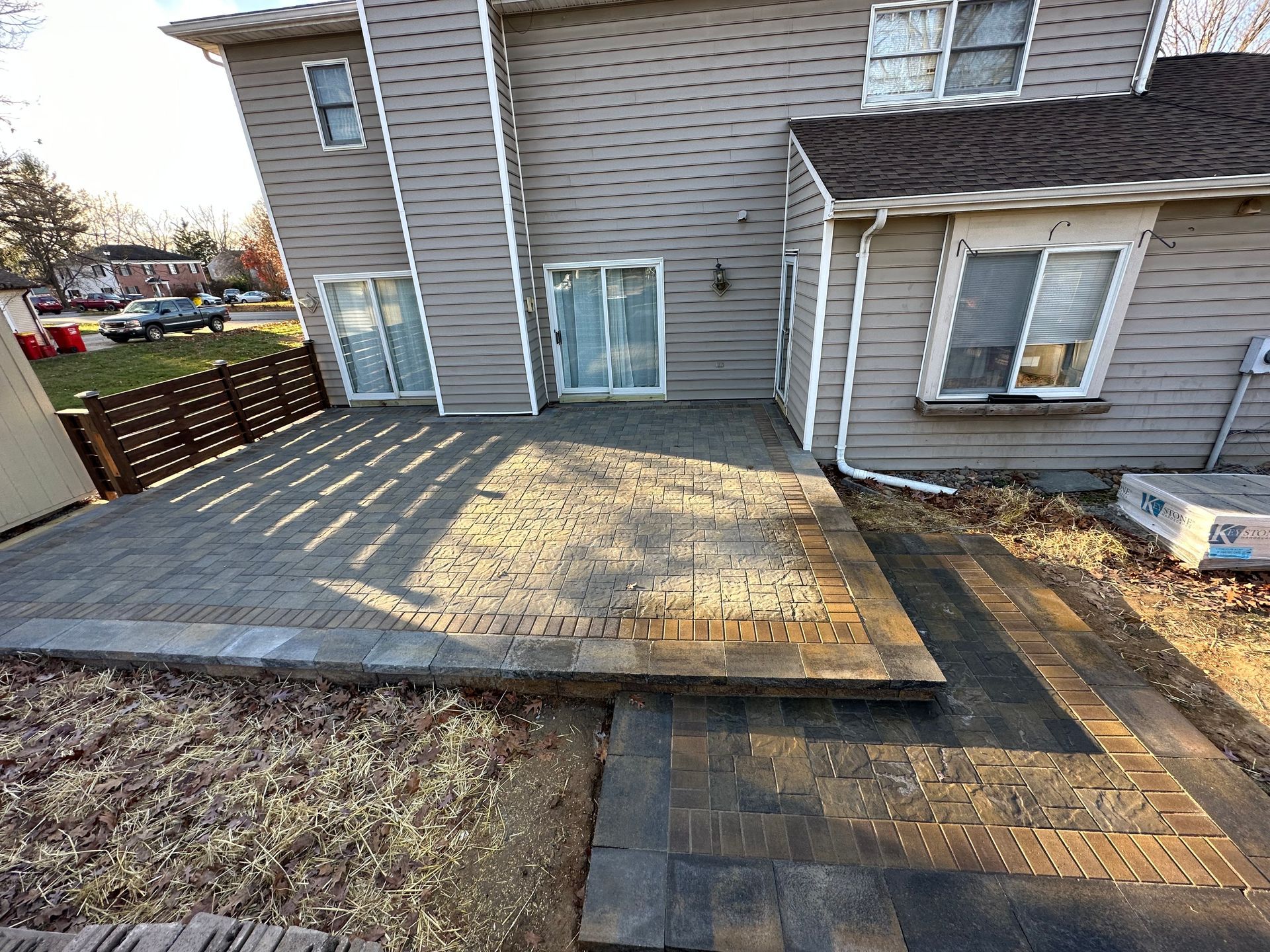 A large house with a patio in front of it.