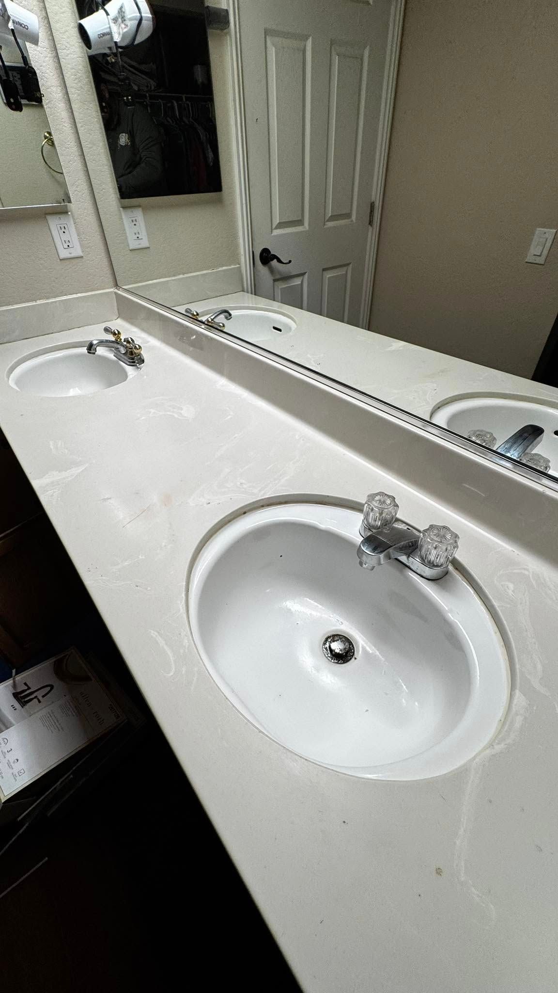 A bathroom with two sinks and a mirror.