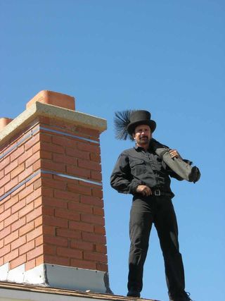 Chimney Flue Cleaning — A Man Standing on the Rooftop in Wasatch Front, UT