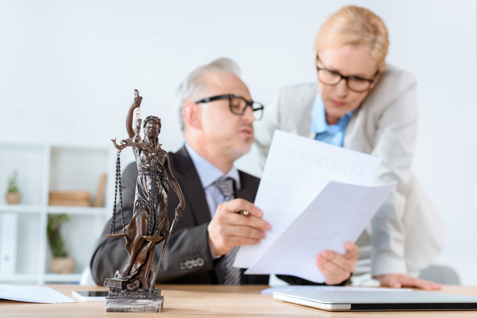 A man and a woman are looking at a piece of paper.