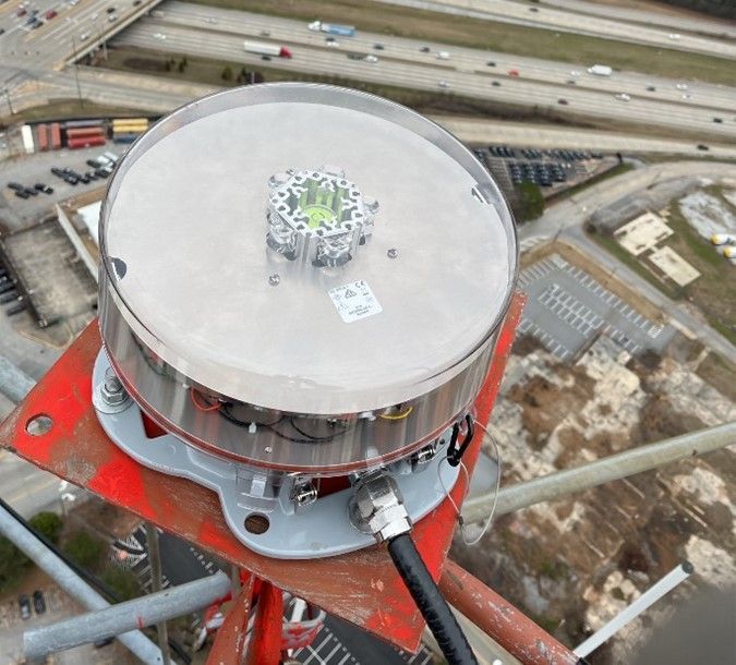 An aerial view of a tower with a light on top of it