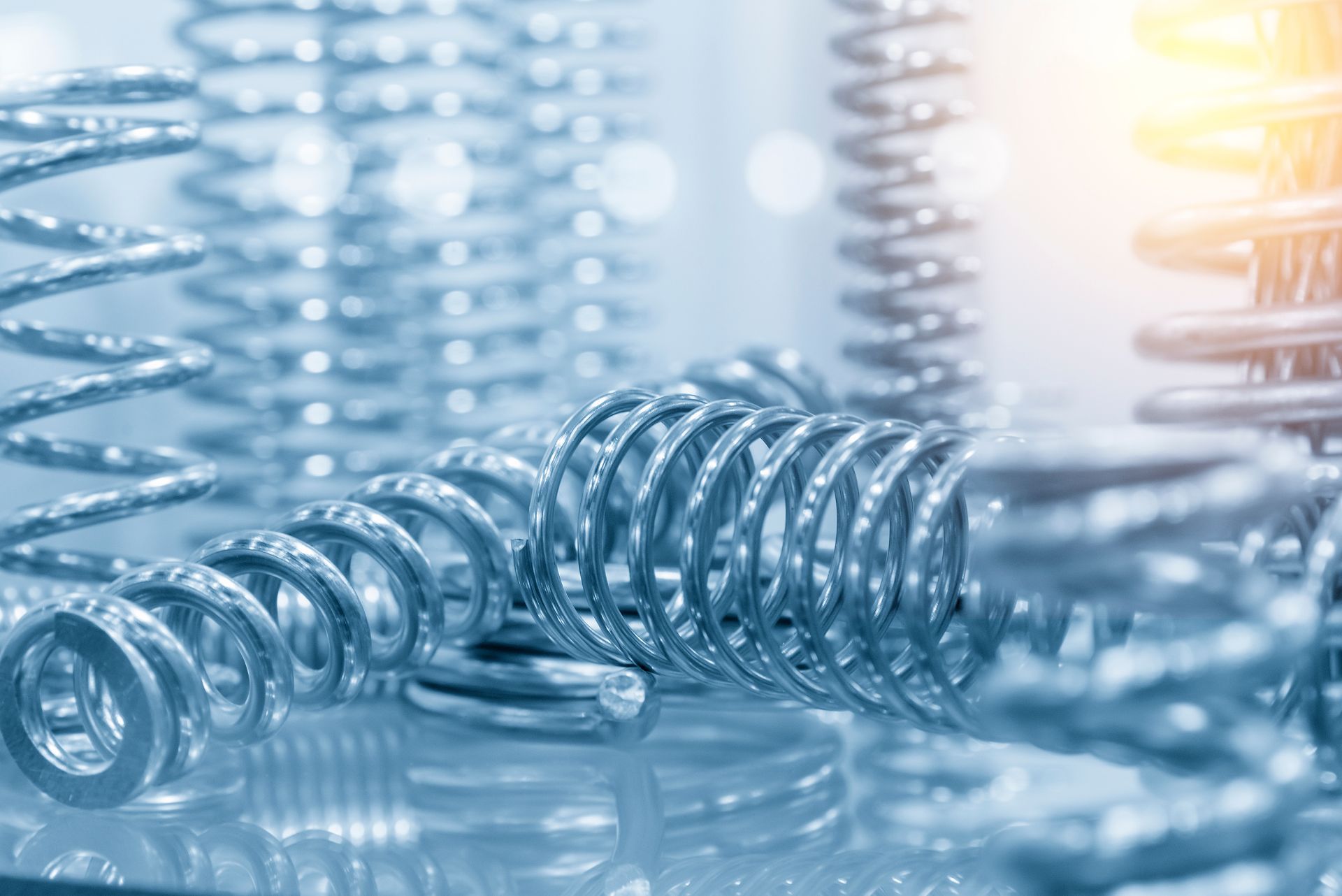 High-quality compression spring supplier parts, close-up on a bright factory floor.