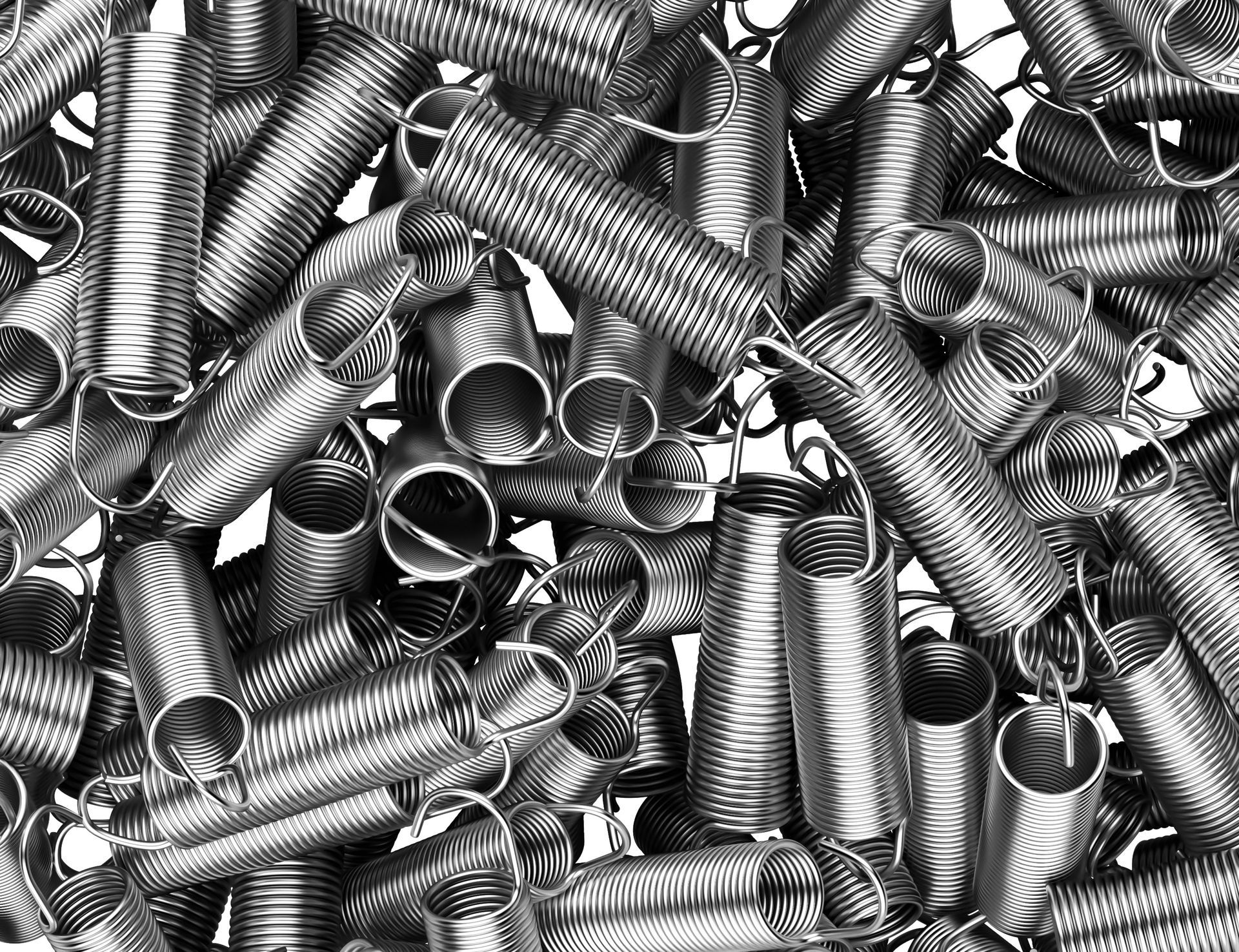 Close up of a pile of metal extension springs arranged in a random pattern.