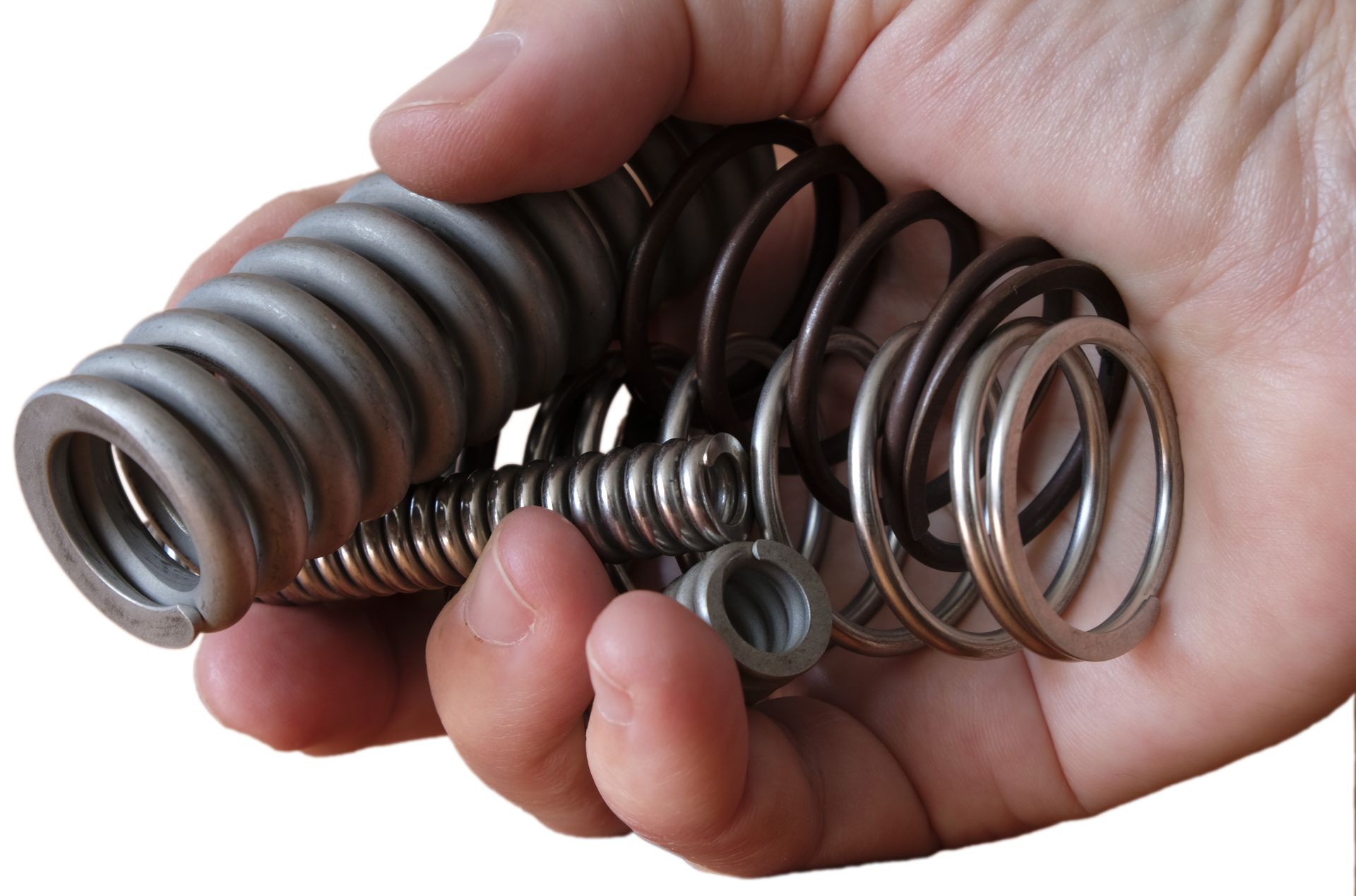 Hand holding a collection of metal springs and small hardware parts. Hand holding a collection of metal springs and small hardware parts.