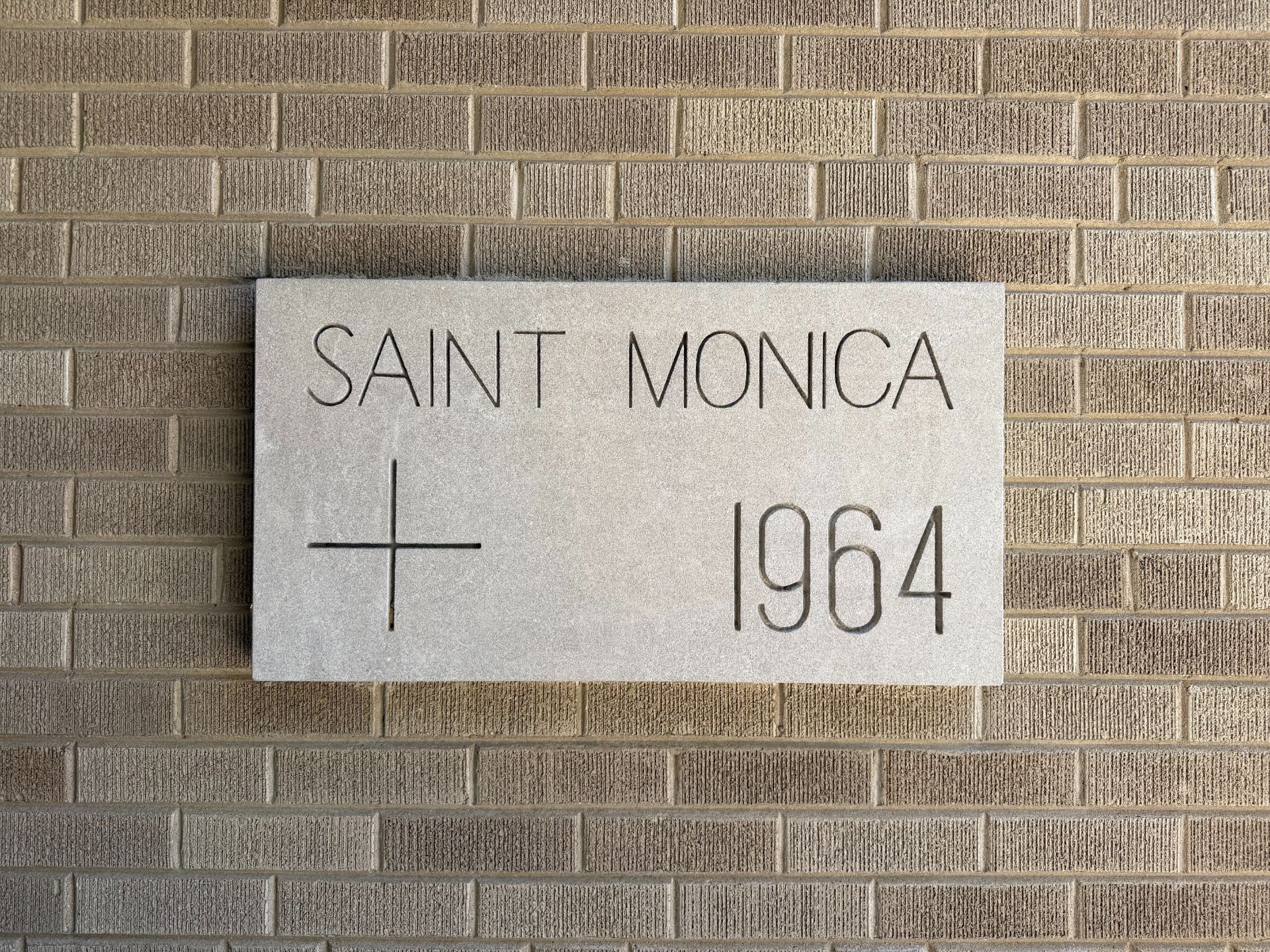 Stone plaque on brick wall: 