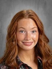 White Celtic knot shamrock on a green background.