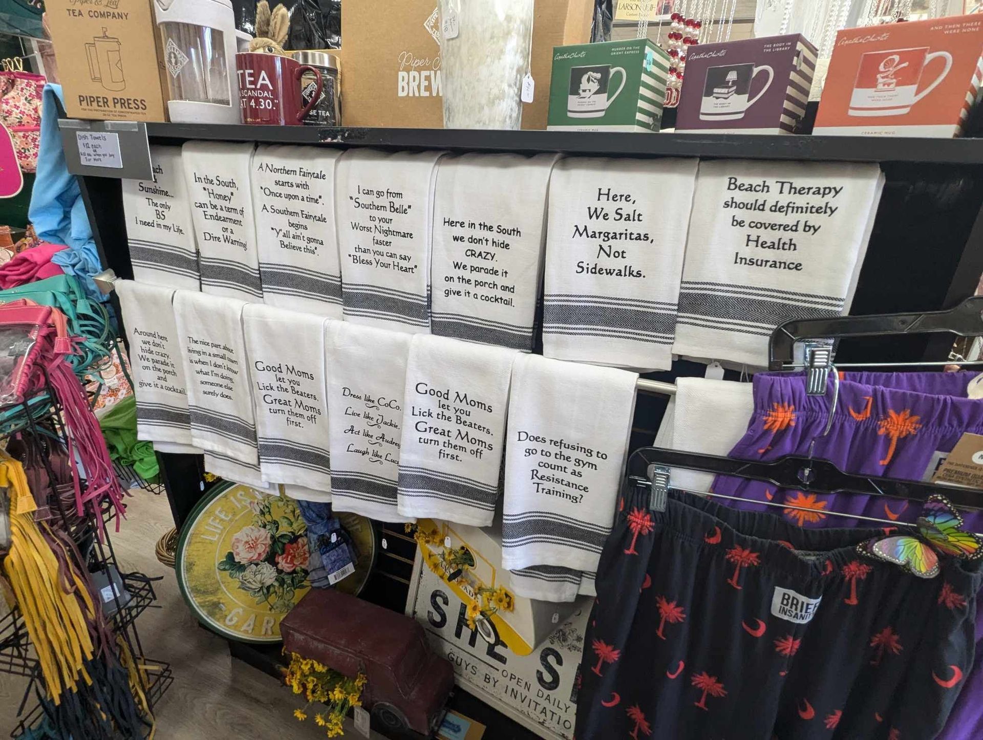 A Shelf Filled with Towels and Other Items in a Store — Summerville, SC — Donovan's Custom Framing and Gifts