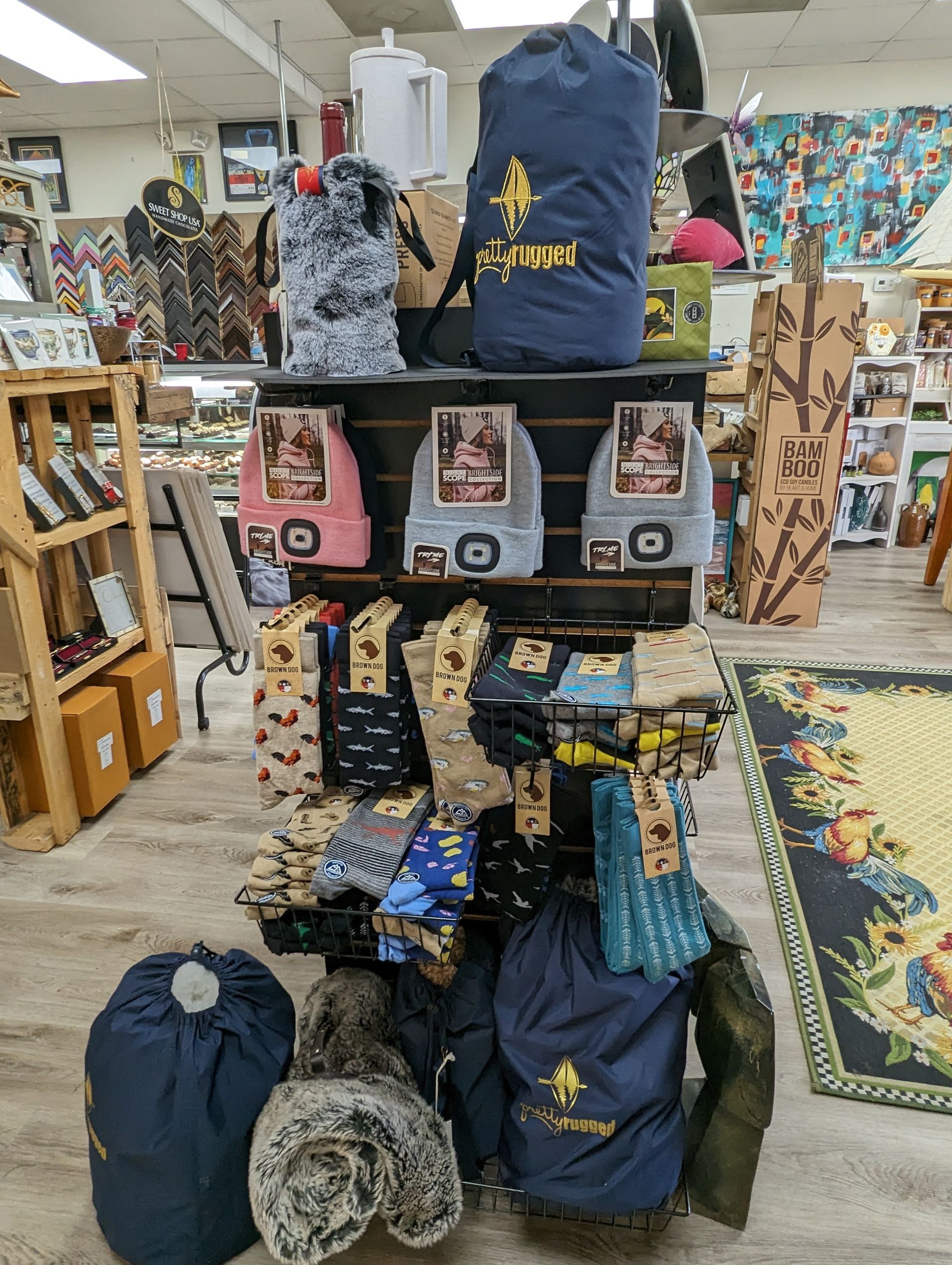 A Shelf Filled with Lots of Bags and Blankets on Display — Summerville, SC — Donovan's Custom Framing and Gifts