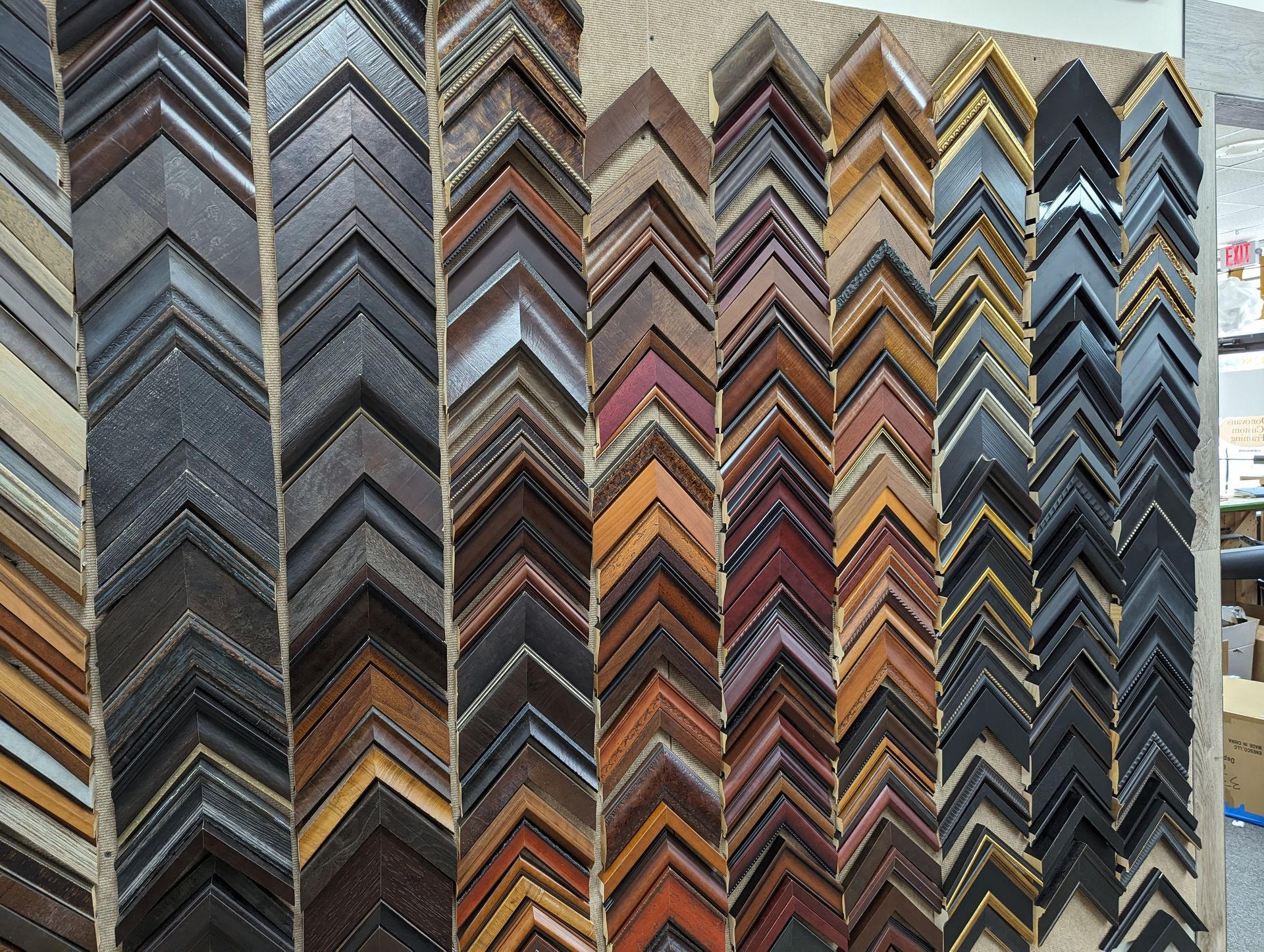 Variety of wooden picture frame samples arranged vertically.