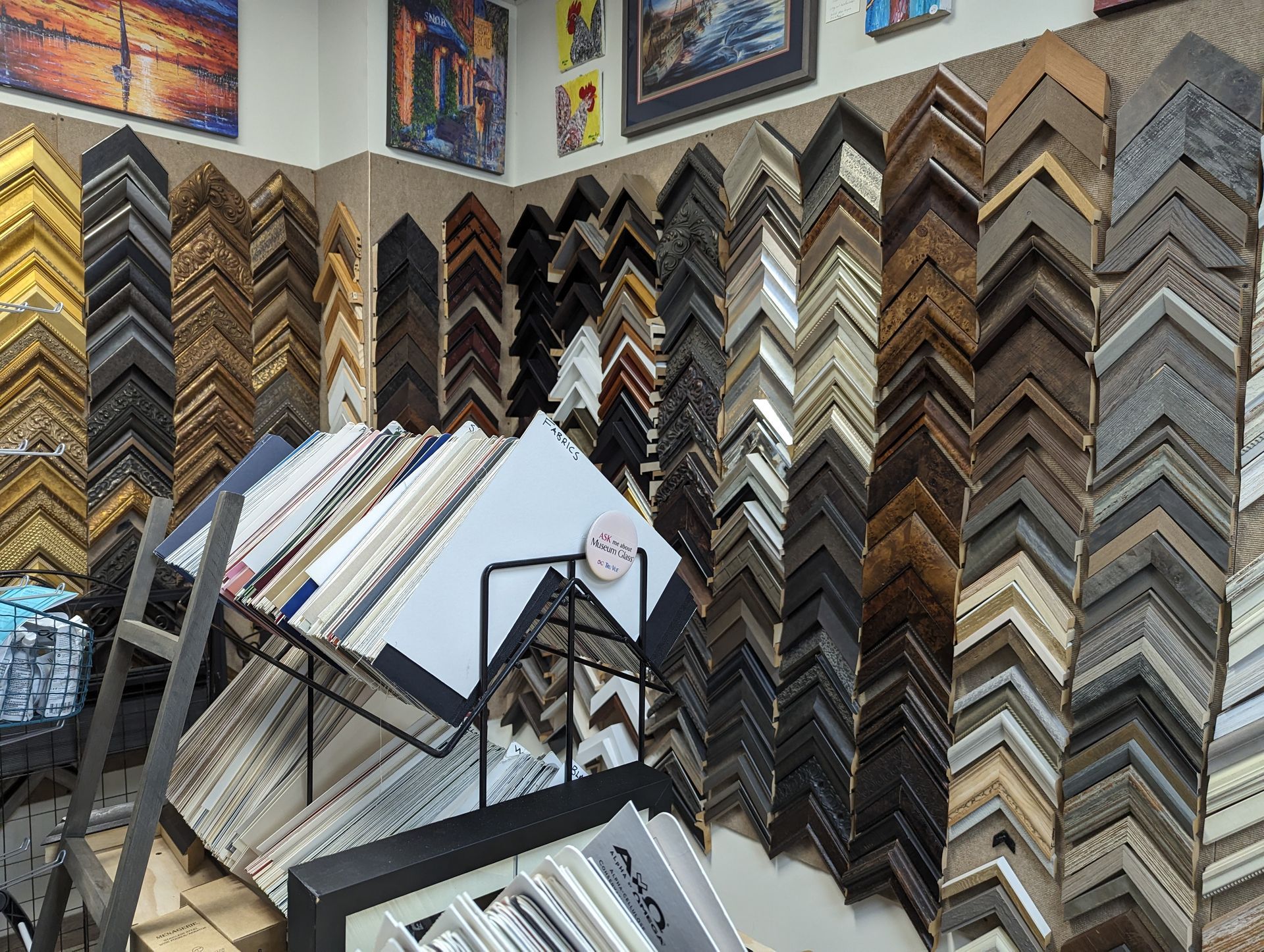 A shop displaying a wide selection of picture frames in various colors, materials, and designs.
