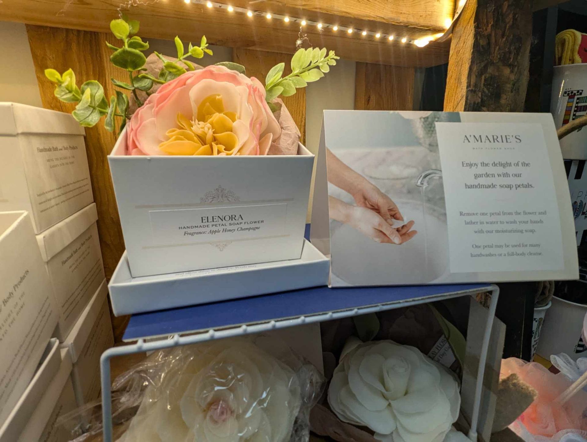 A White Box with a Pink Flower is Sitting on Top of a Shelf — Summerville, SC — Donovan's Custom Framing and Gifts