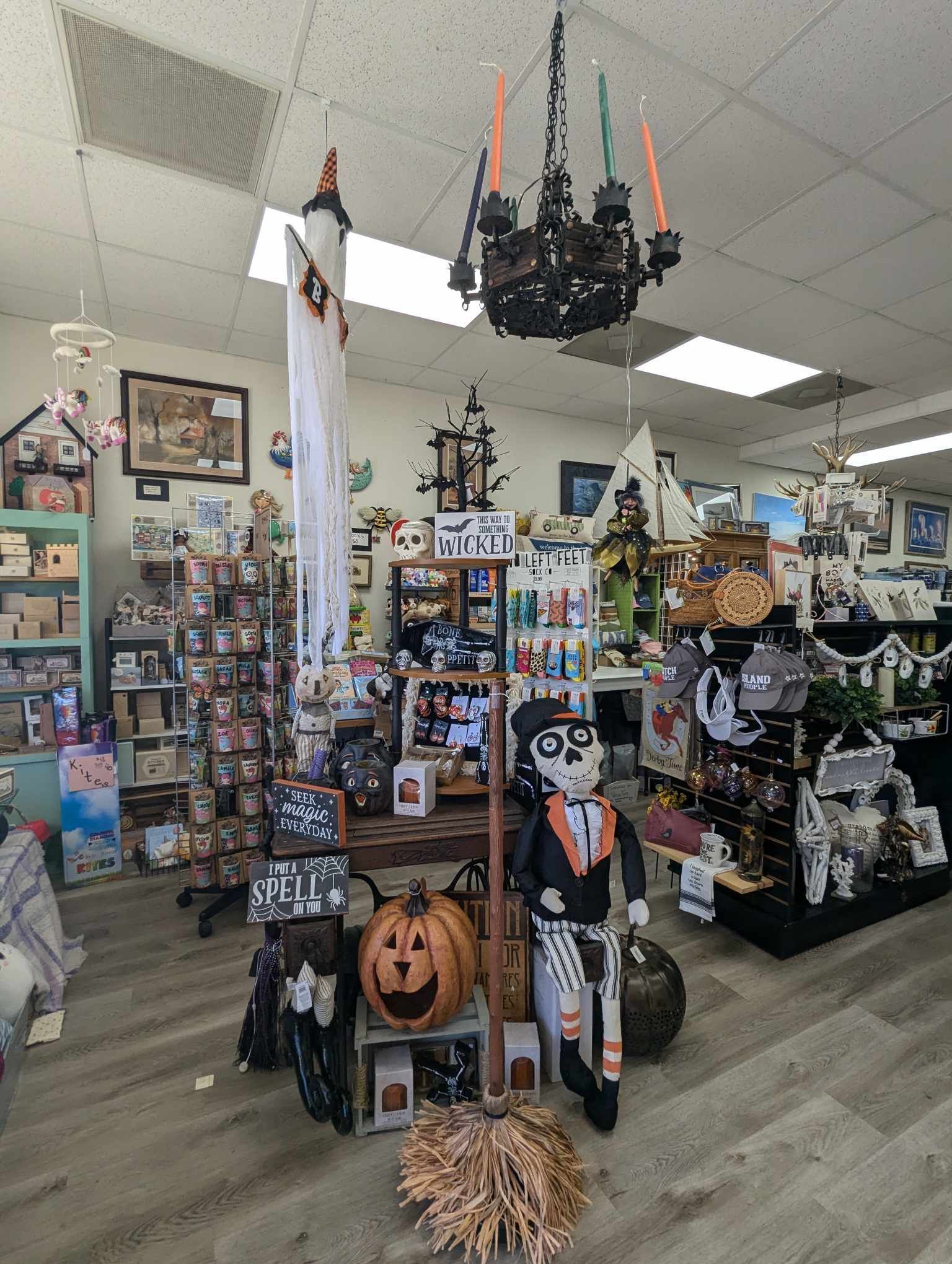 Inside a store, Halloween decorations and merchandise are displayed.