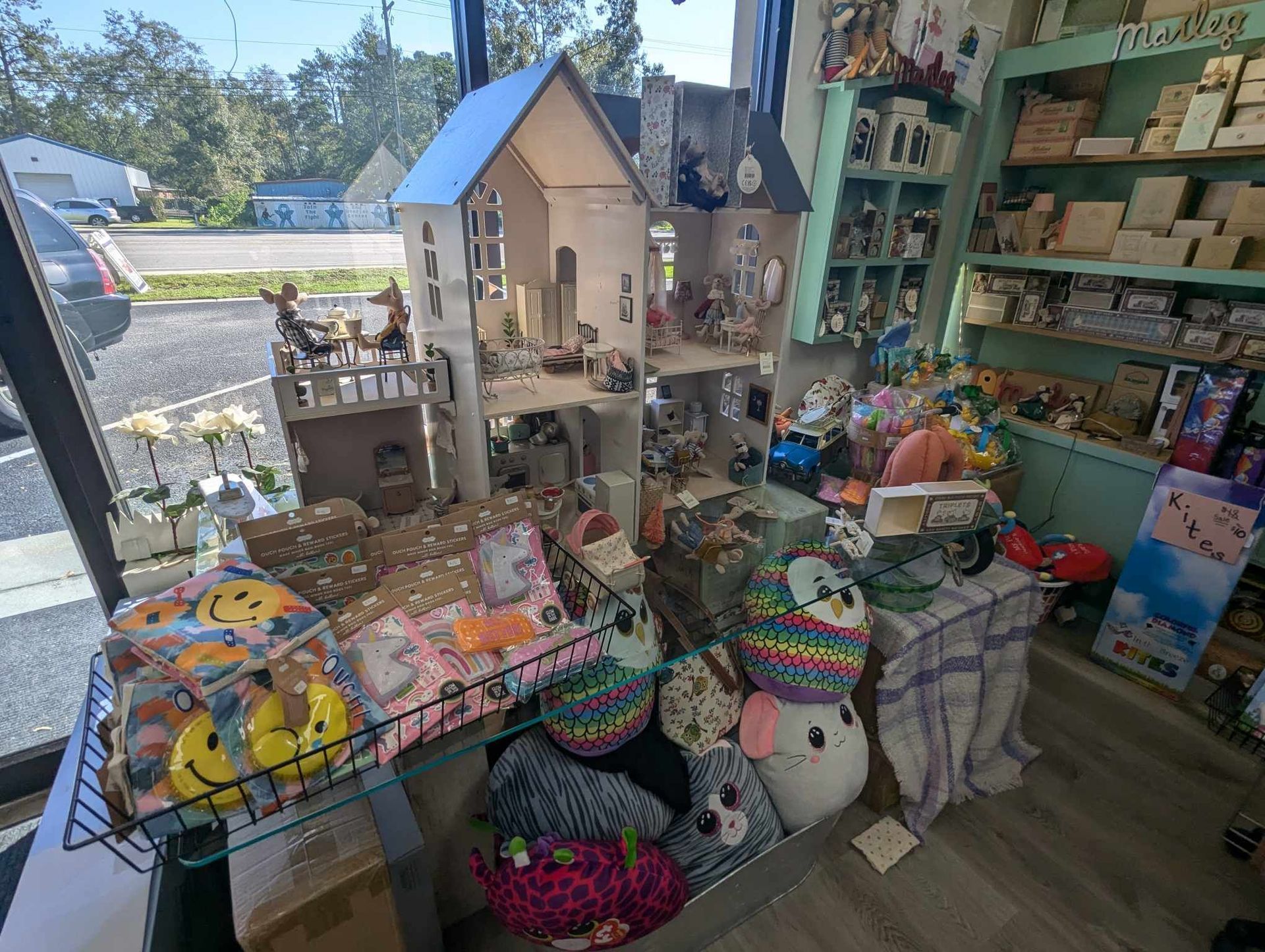 A Doll House Sits on Top of a Table in a Store — Summerville, SC — Donovan's Custom Framing and Gifts