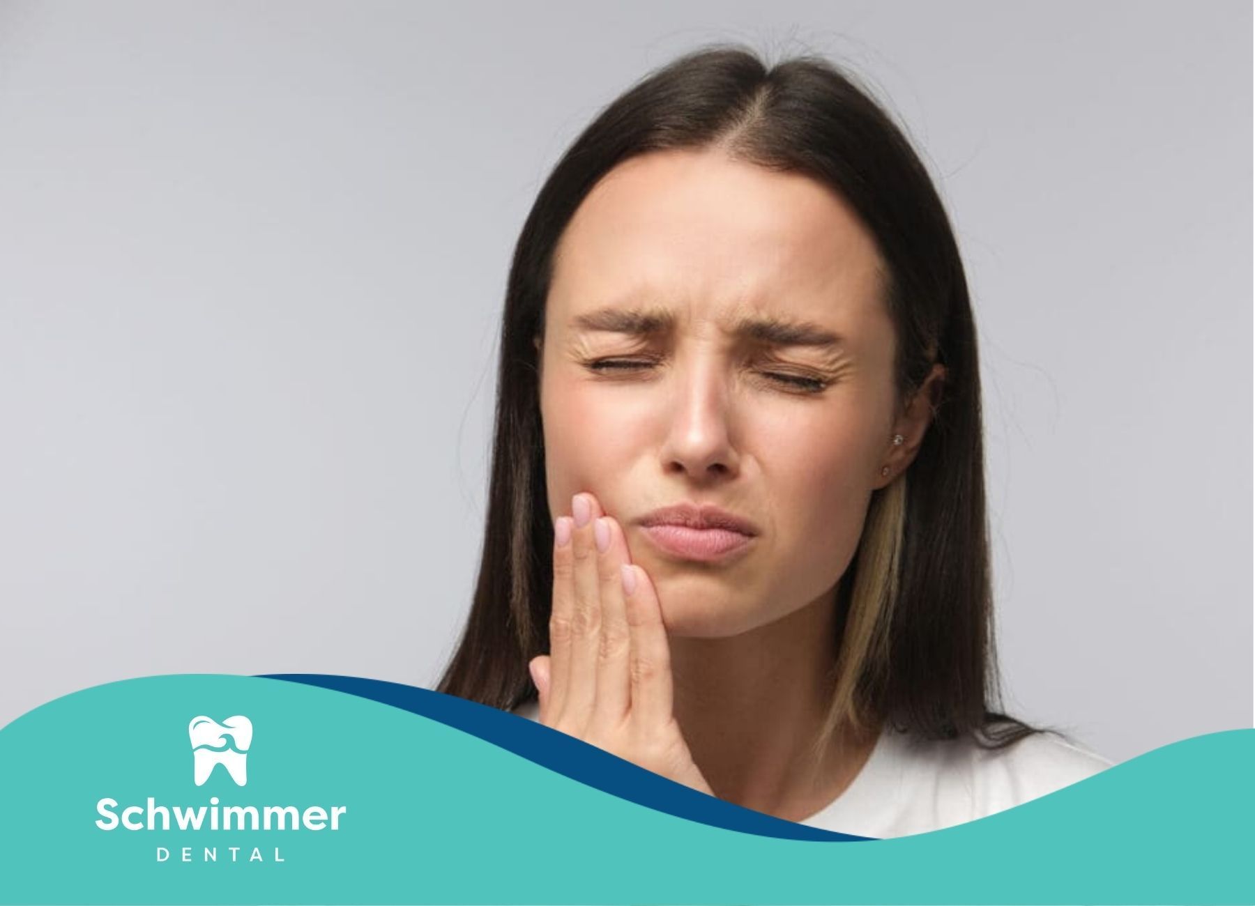 Woman squeezing her eyes and holding her jaw as she suffers from allergic reaction to dental implant