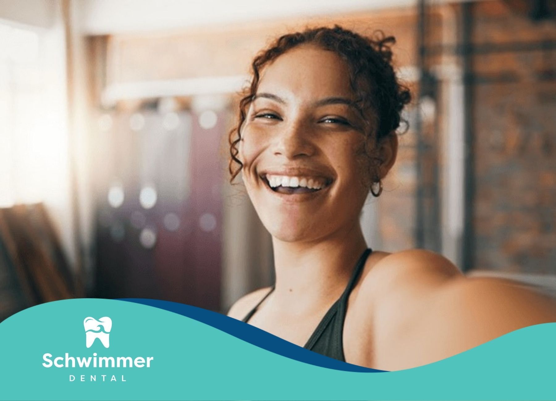 Woman smiling and showing her dental crown with an energetic and happy expression at a gym in NJ.
