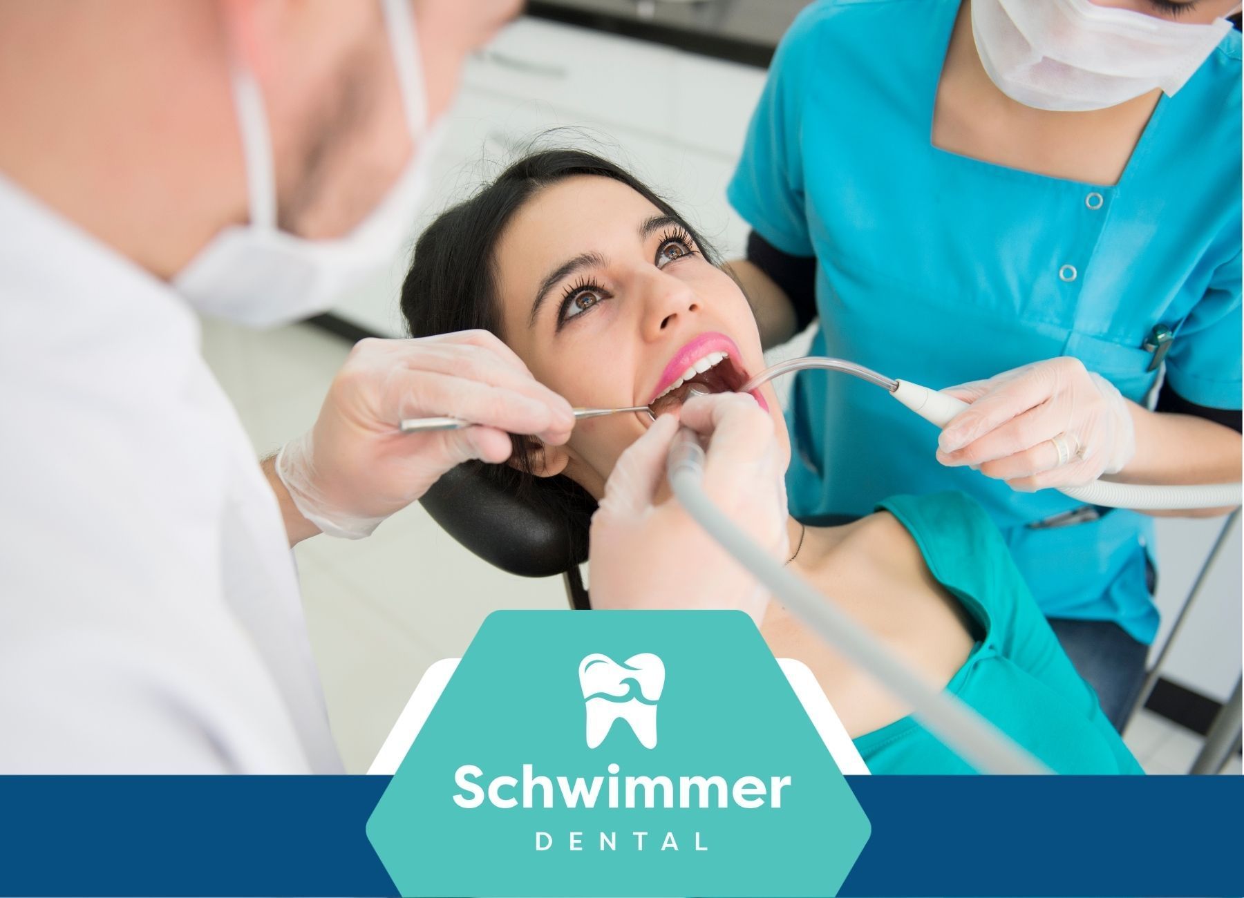 A woman is getting her teeth examined by two dentists at schwimmer dental