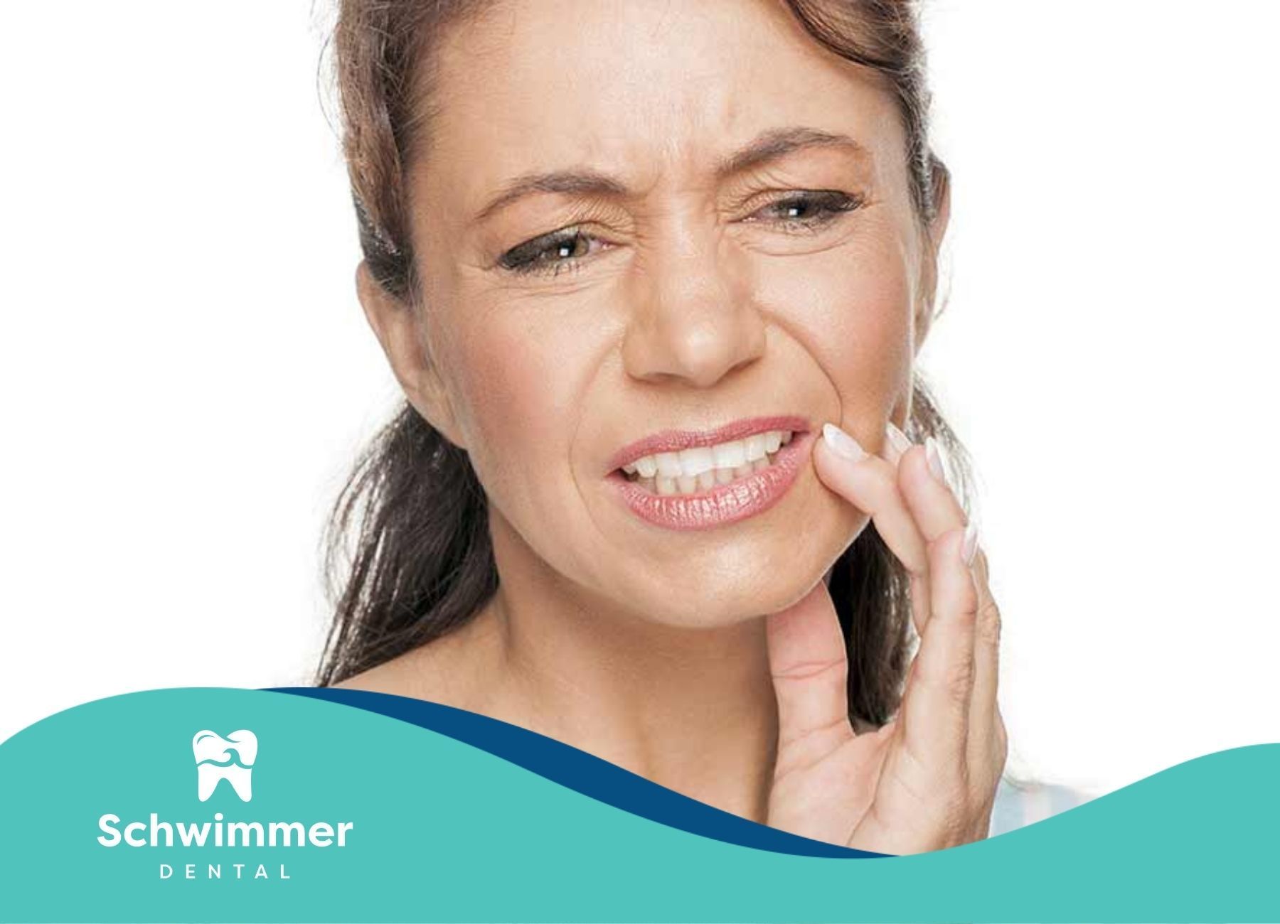 Woman grimacing in discomfort, holding her cheek due to dental implant nerve pain at a clinic in NJ.