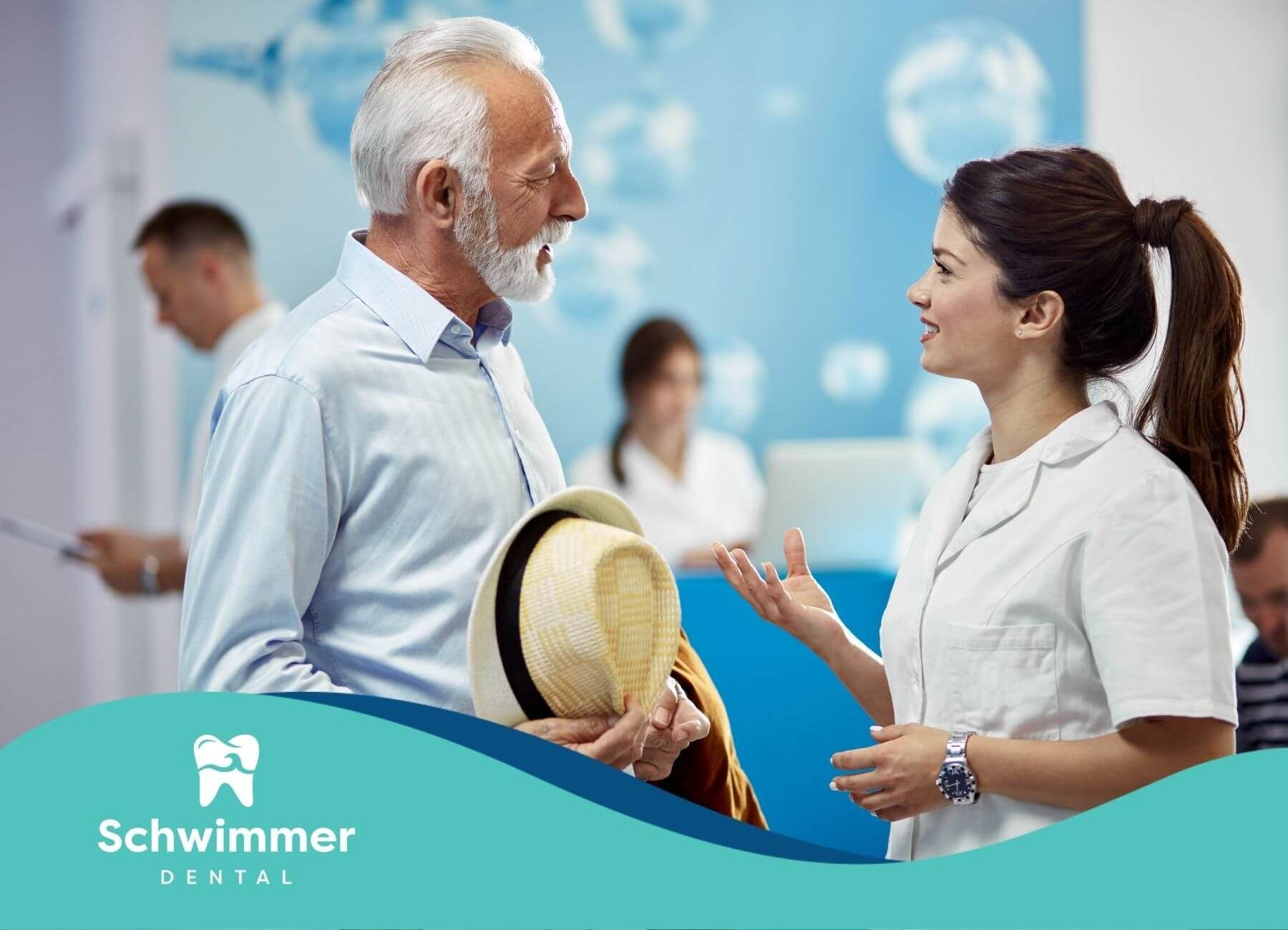 An elderly man and a healthcare professional engaging in a conversation in a medical setting.