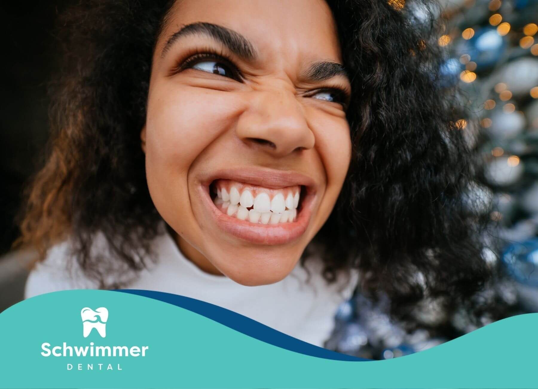 Smiling woman showing bright, healthy teeth in a close-up portrait that highlights confident