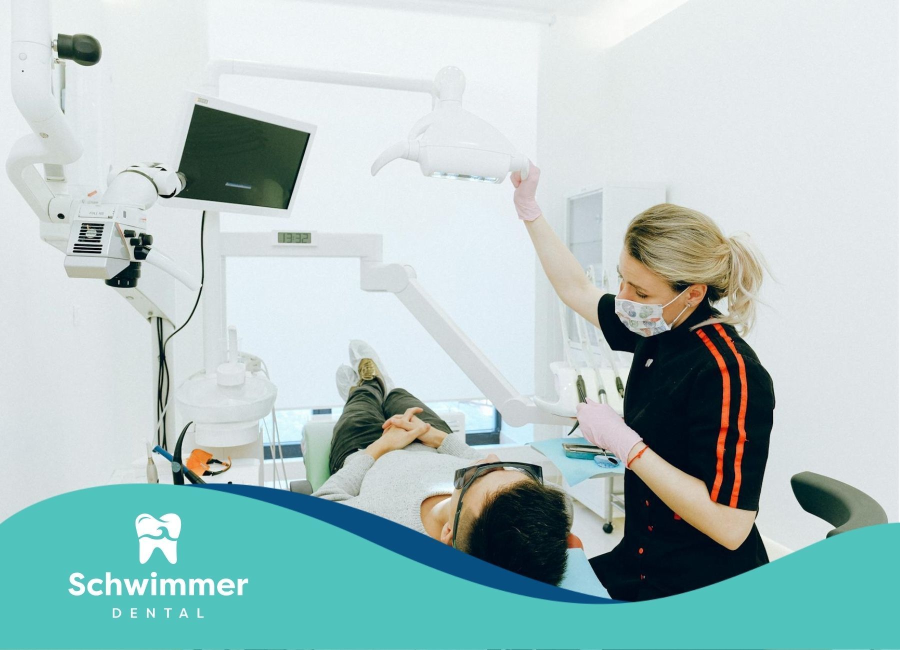 Dental hygienist adjusting equipment while attending to a patient at a clinic in Point Pleasant, NJ.