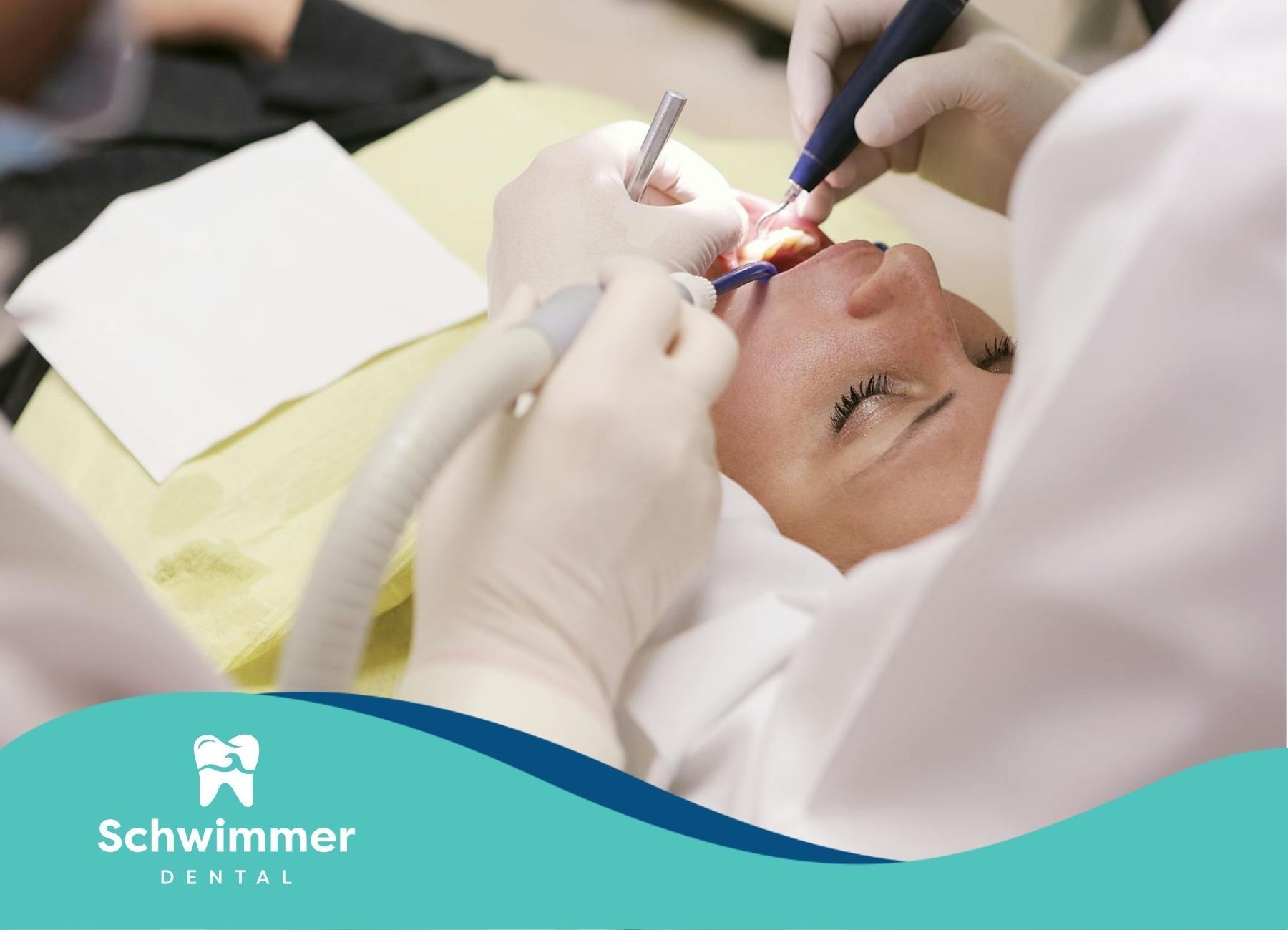 Dentist and assistant working on a patient's dental procedure at a clinic in Point Pleasant, NJ.