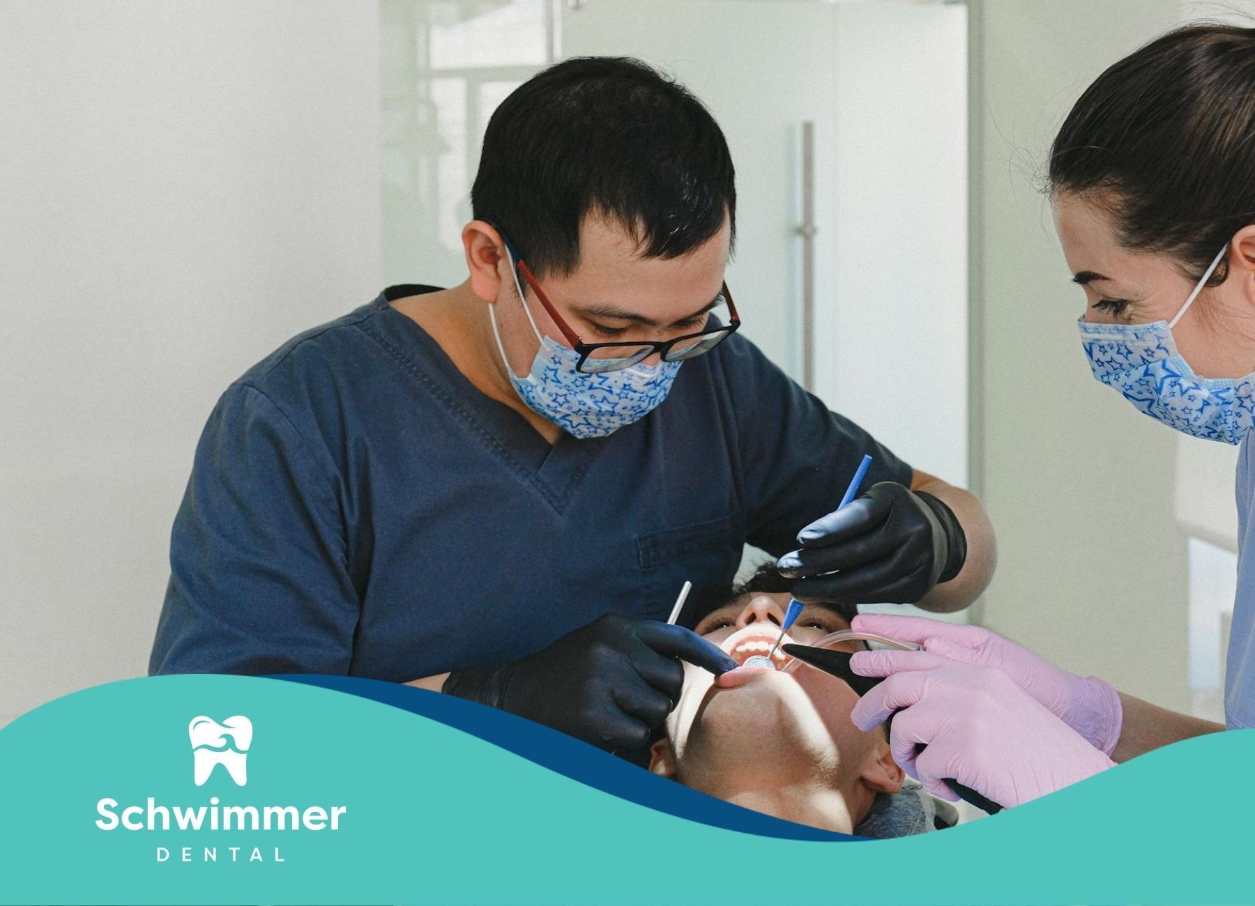 Two dental professionals thoroughly examining on a patient’s teeth at a dental clinic in New Jersey.