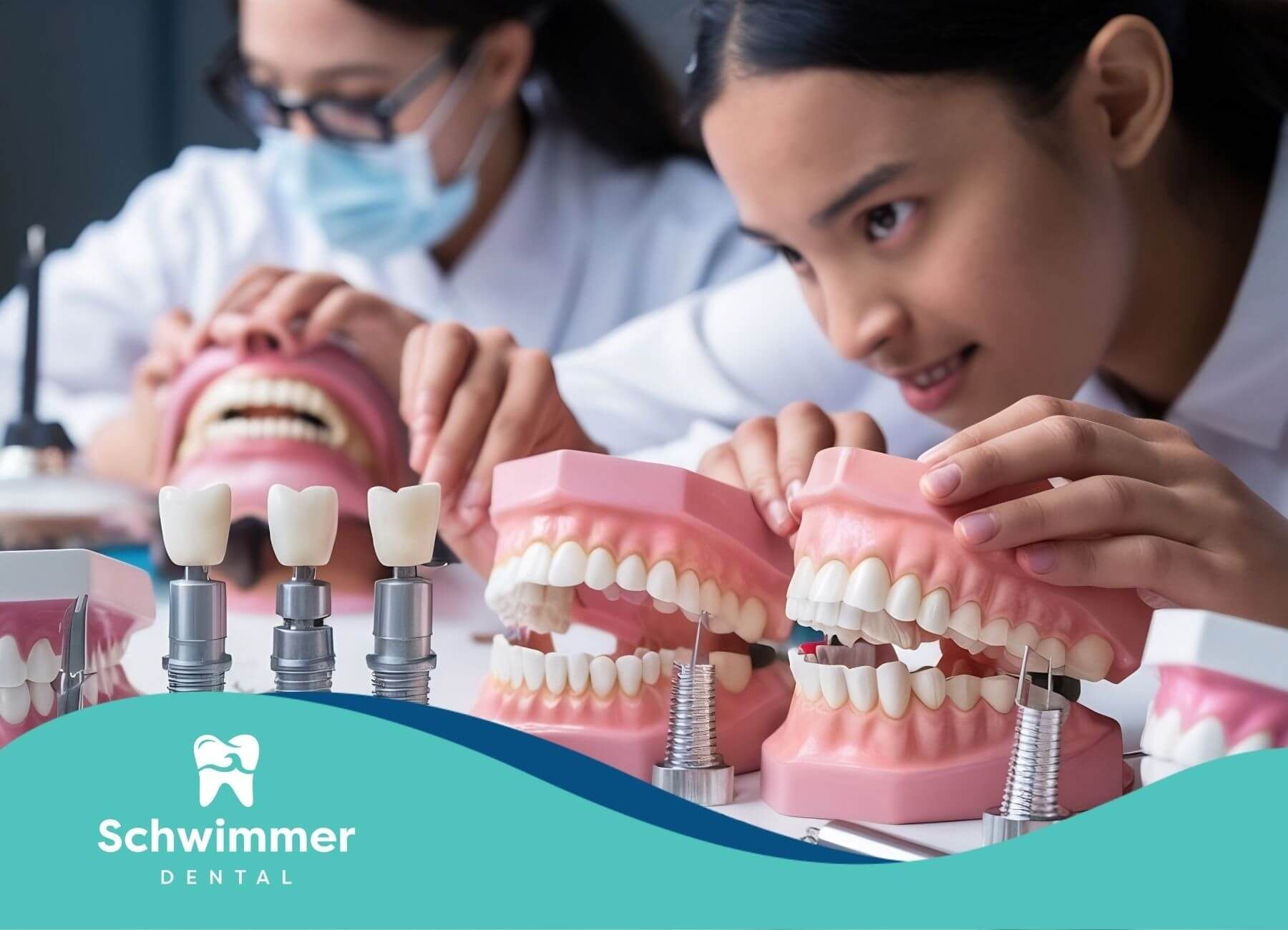 Dental students examining tooth models and implants, learning about prosthetics and restorative