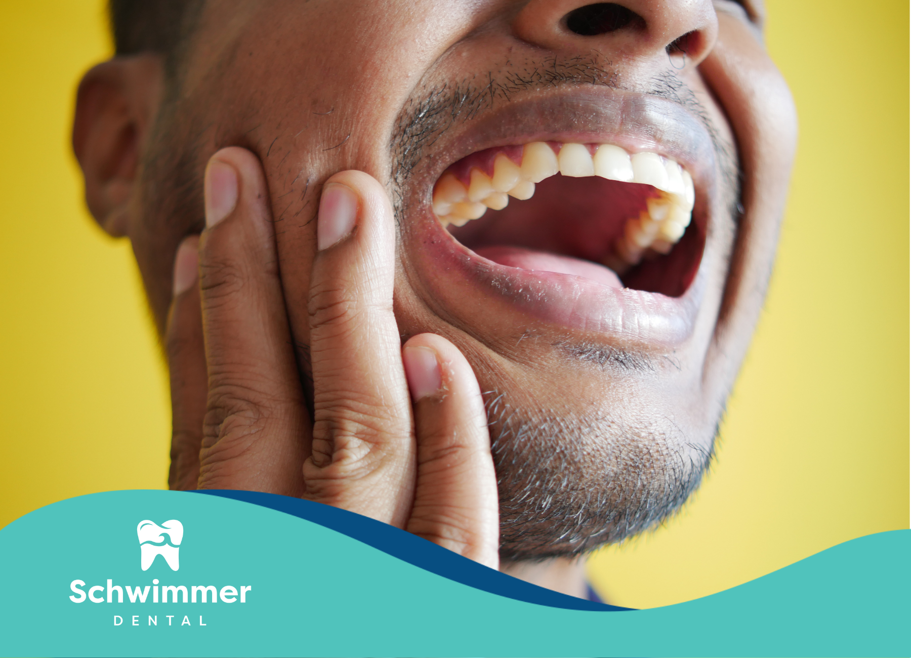 A man is holding his face in pain because of a toothache.