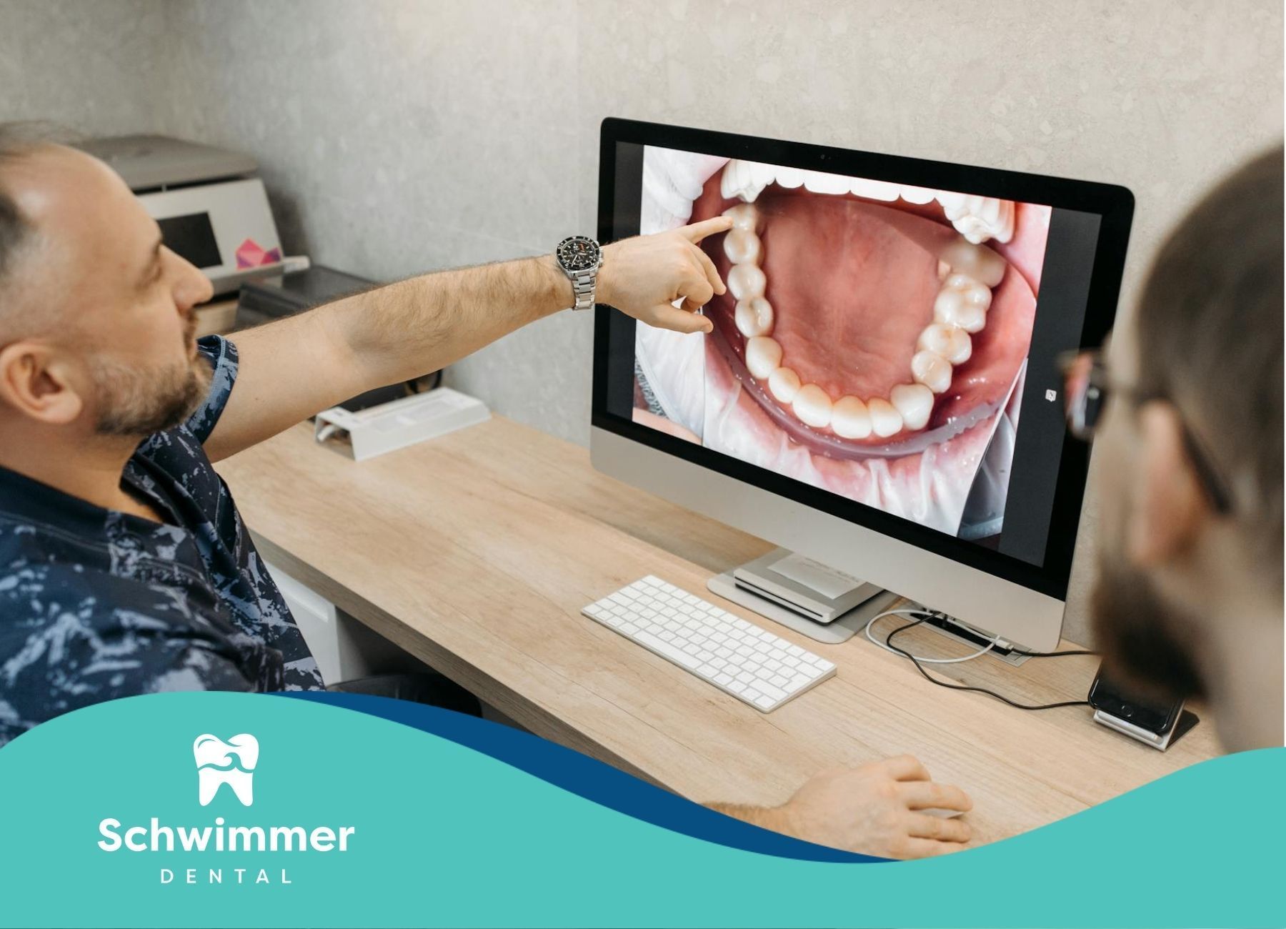 Dentist pointing at a dental x-ray or mouth scan on a computer monitor in Point Pleasant Beach, NJ.