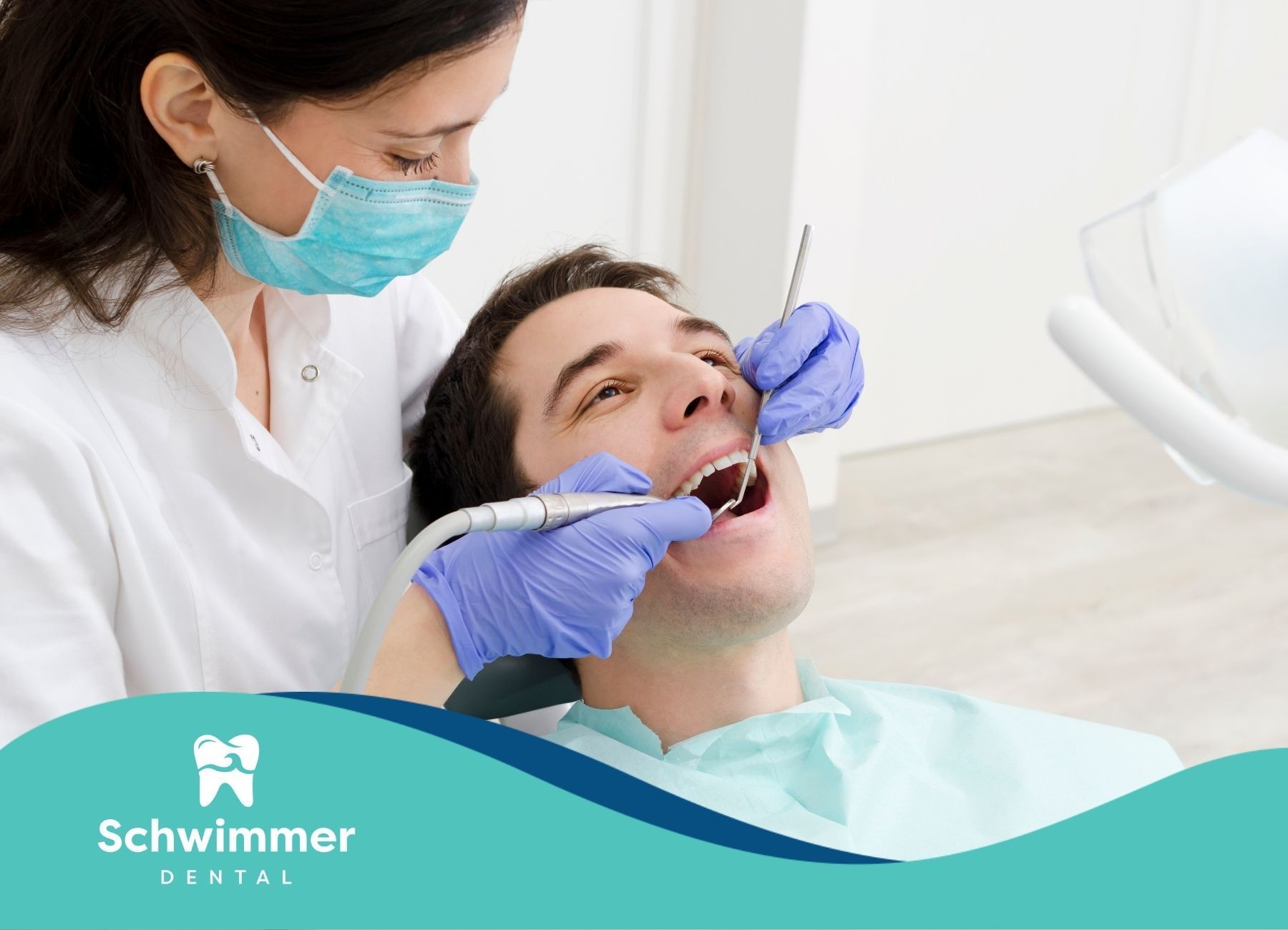 A man is getting his teeth examined by a female dentist.