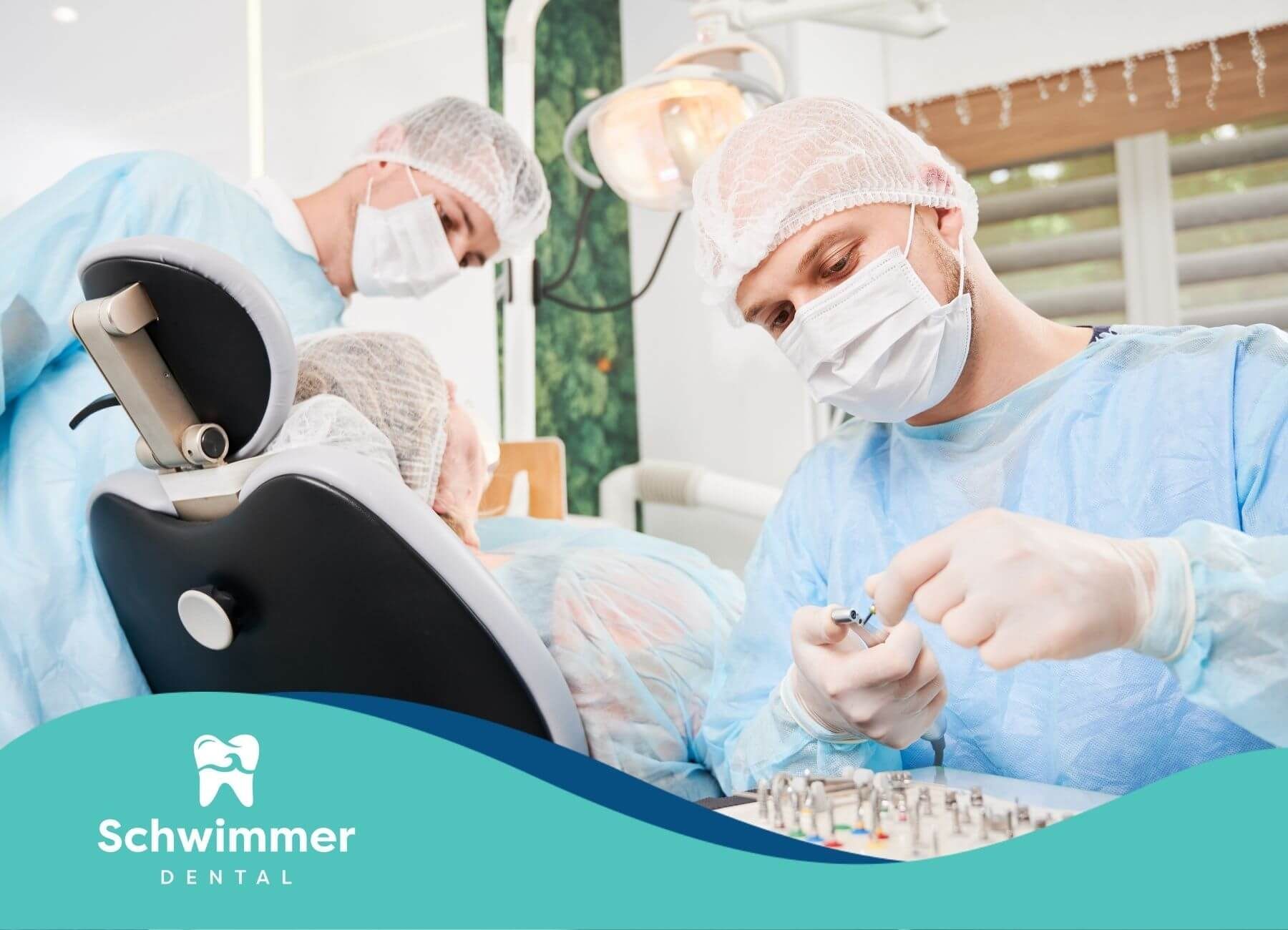 Dental surgeons in protective gear preparing implants during an advanced surgical dental procedure