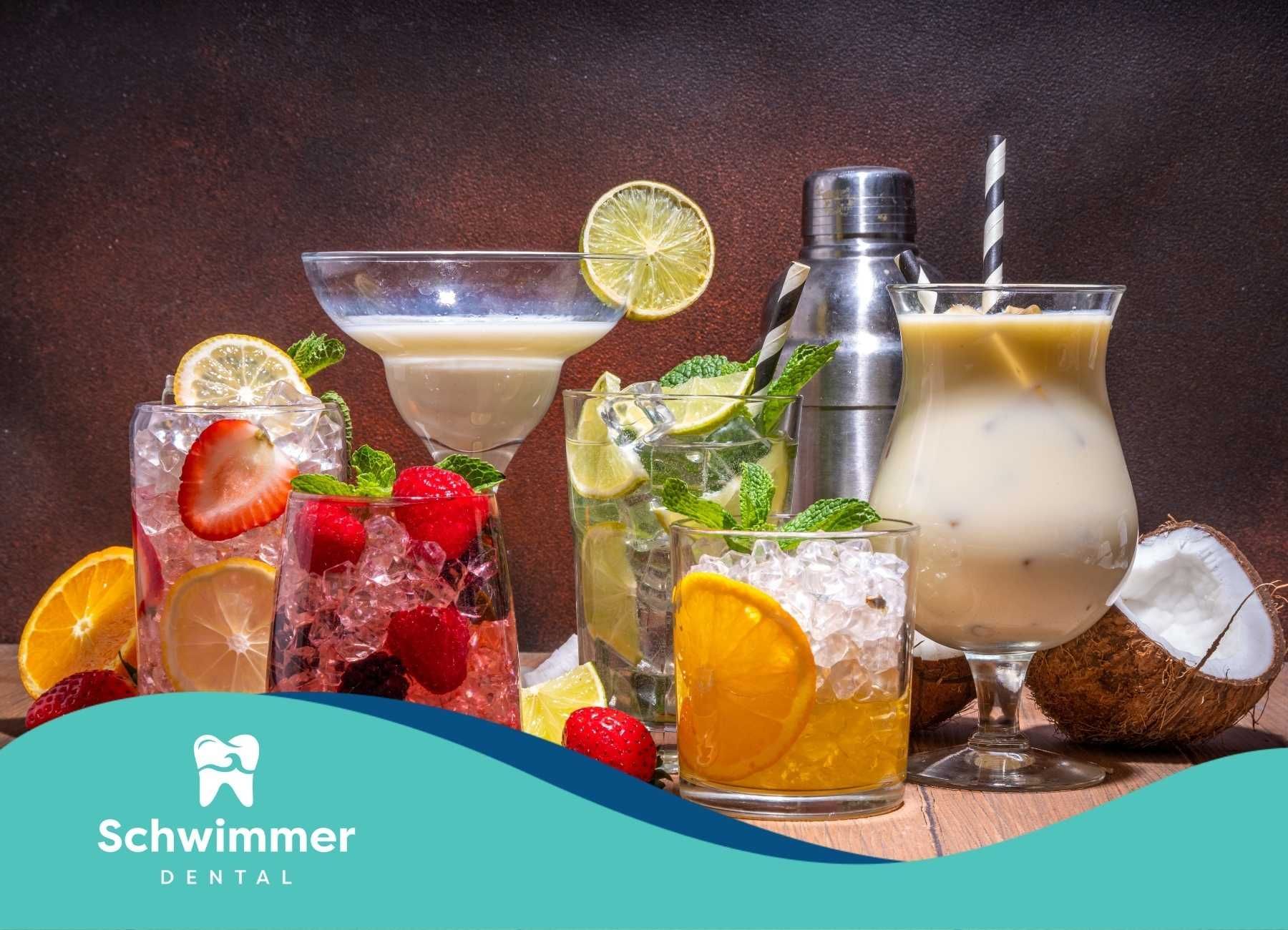 Cocktails on a wooden surface, including a margarita, mojito, and other fruity drinks.