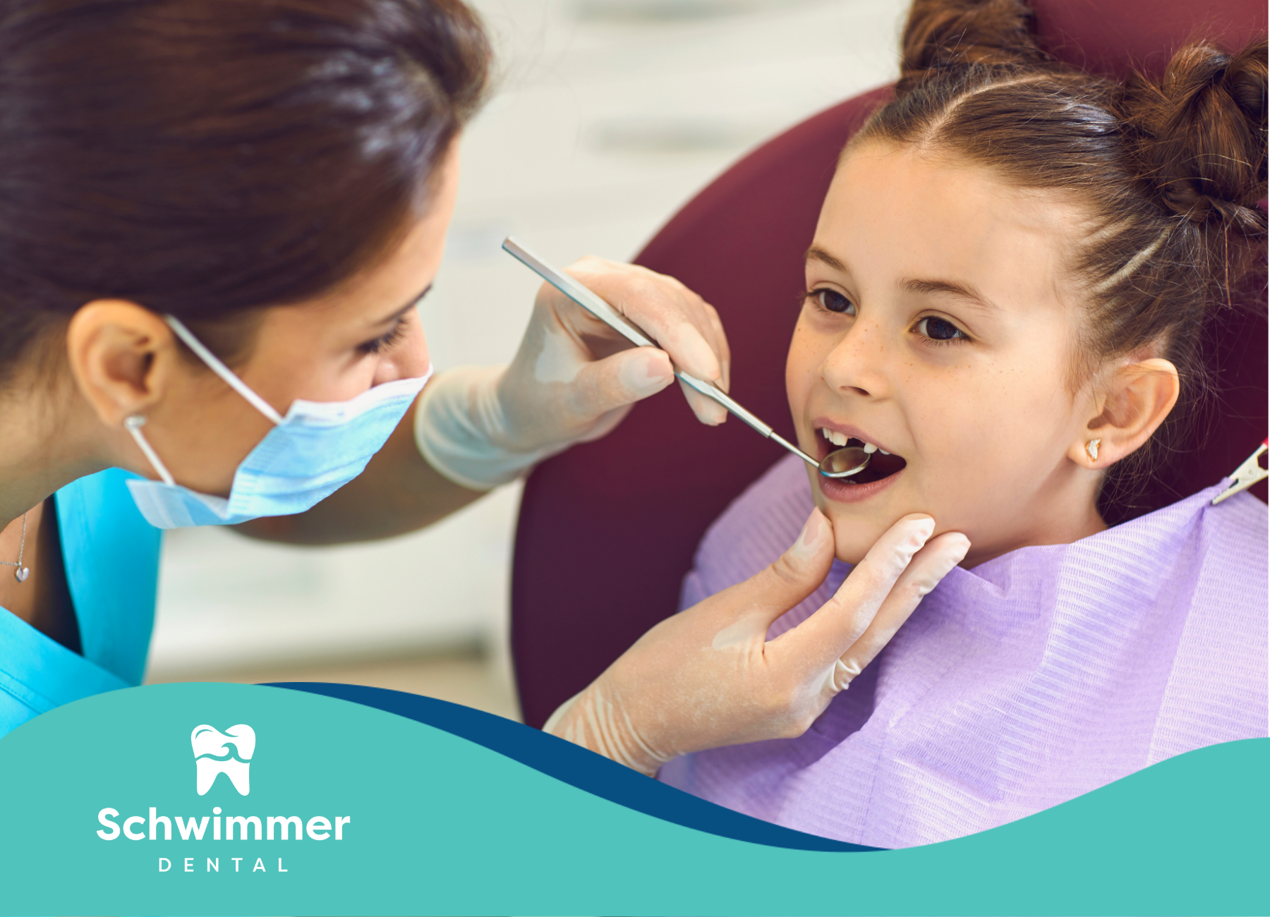 A little girl is getting her teeth examined by a dentist.