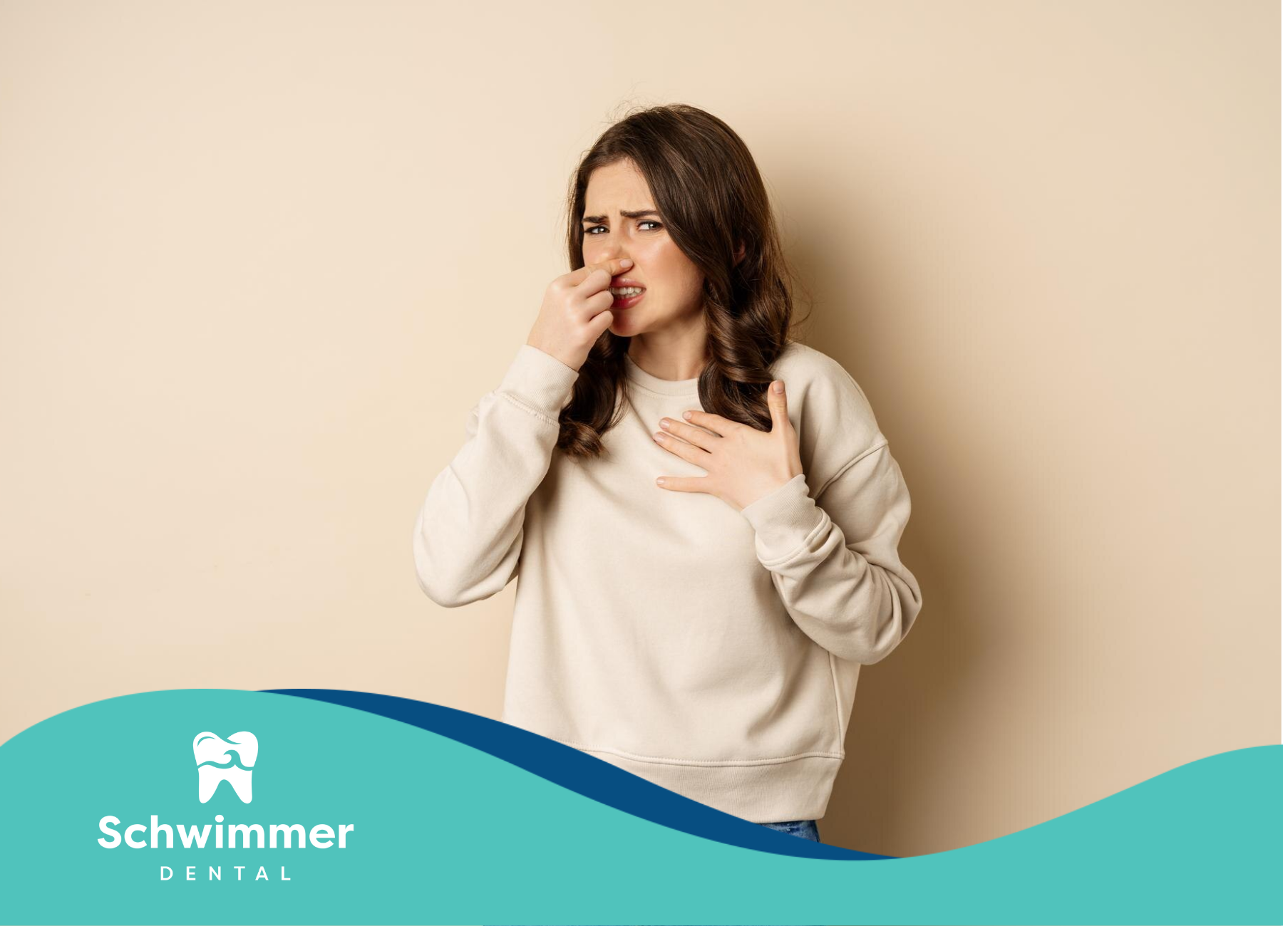 A woman is covering her nose because of a bad smell.